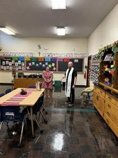 Father Ryan blessing Senora Leiva's classroom. 