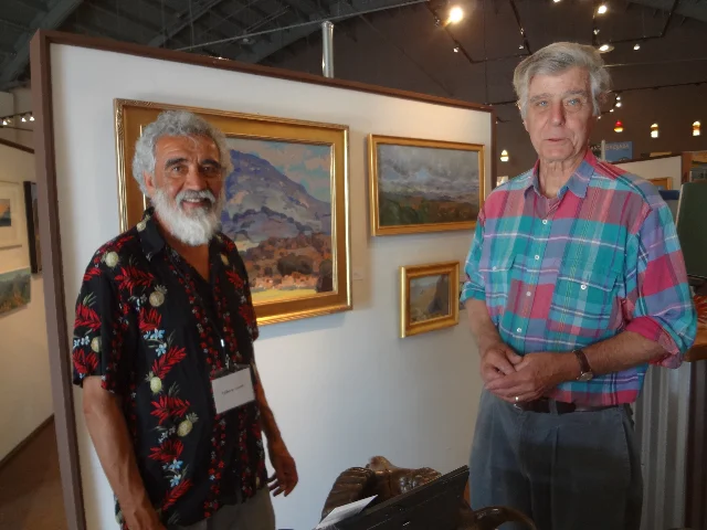 Artists/Scape Board members Filiberto Lomeli and Don Crocker at exhibit wall