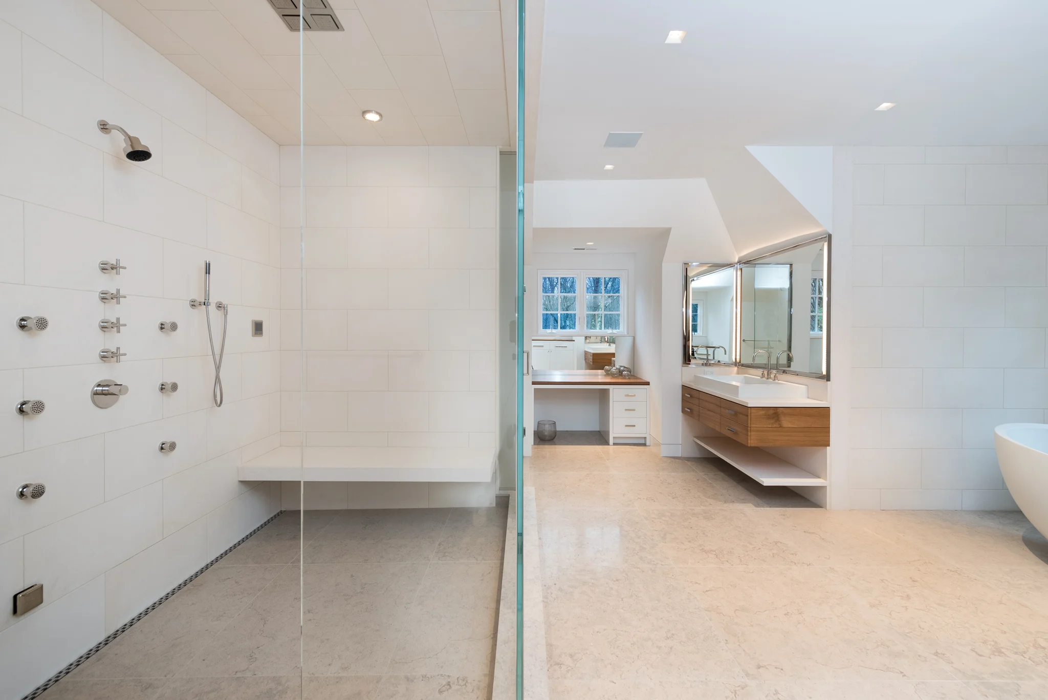 OVERALL: The shower includes a ceiling mounted rain head, a wall mounted shower head, a handheld shower and 6 body sprays - all of which can be turned on simultaneously without any water pressure reduction. The floating limestone bench allows a place to sit in the steam shower.