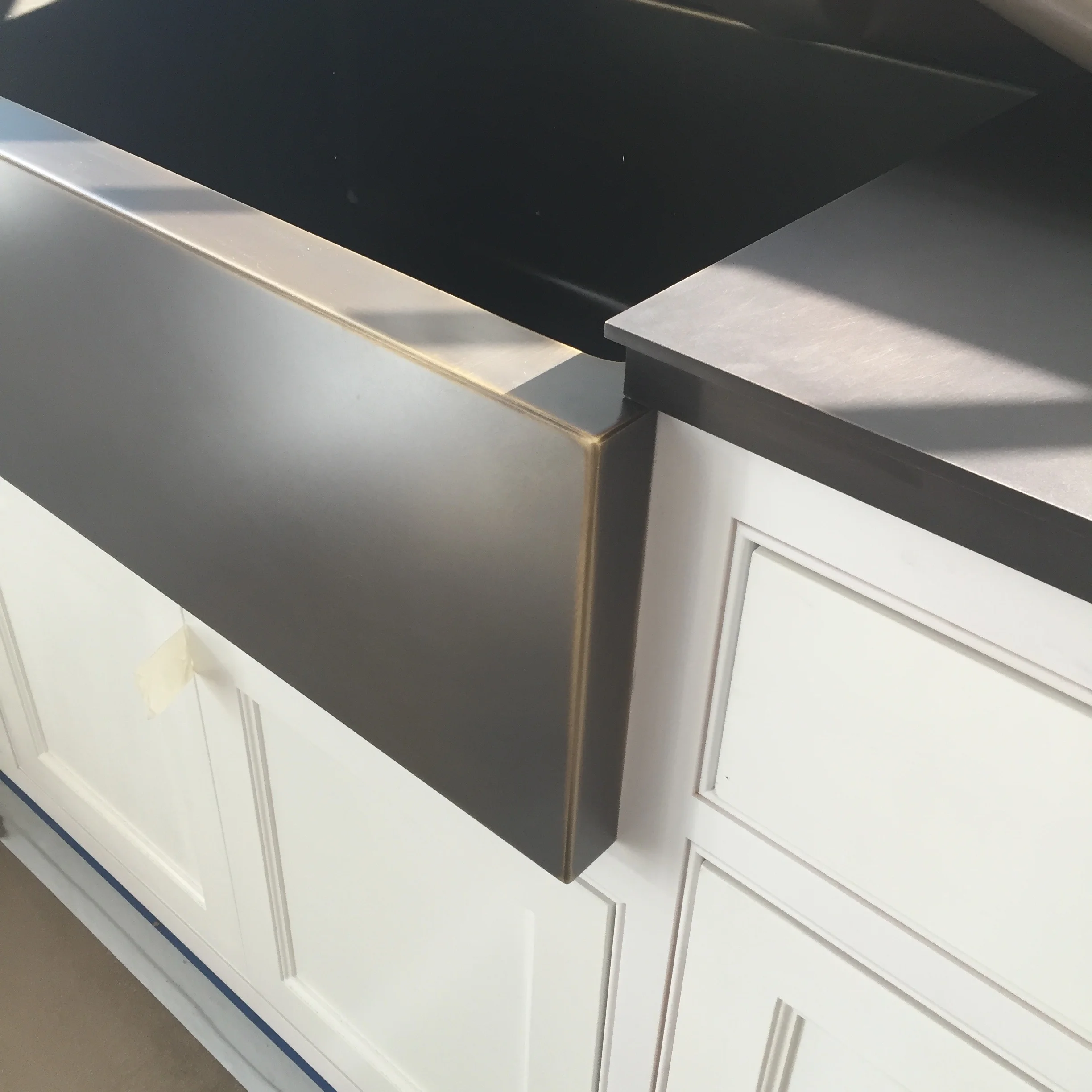 MUDROOM CABINETRY DETAIL: Here is a custom bronze farmhouse sink we had made from one of our fabricators in Texas along with a custom bronze countertop we had made locally. 