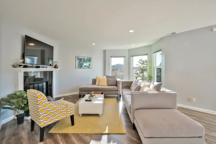 Living+room+couch+angle+windows+tv.webp