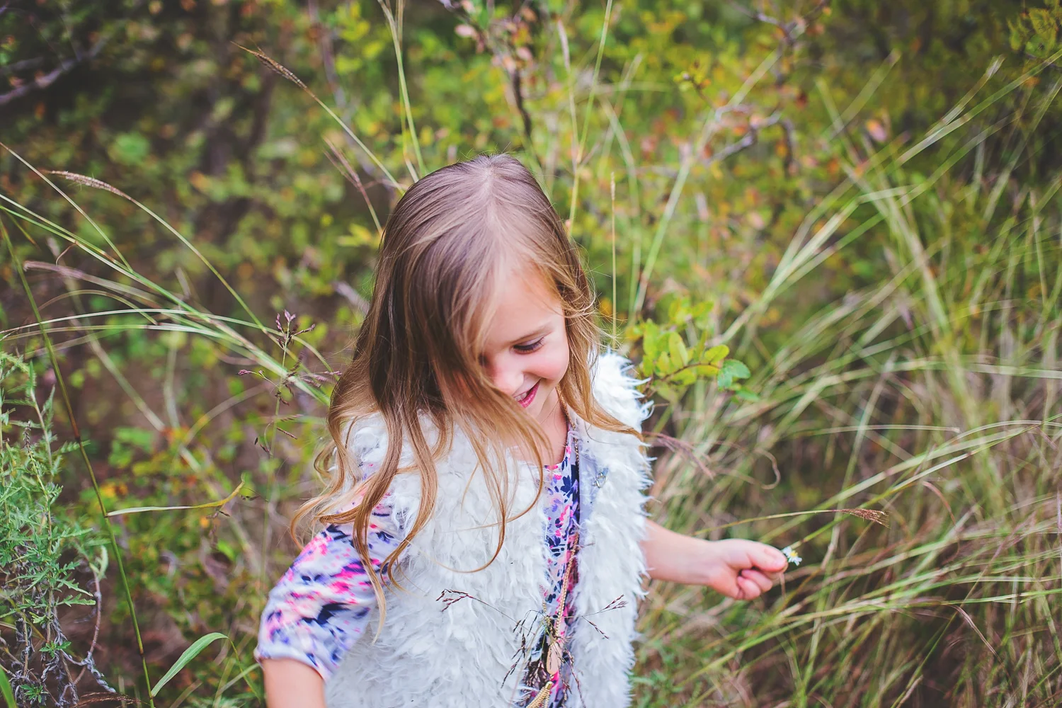 Girl dances and laughs during family portrait session with Jessica Rene.
