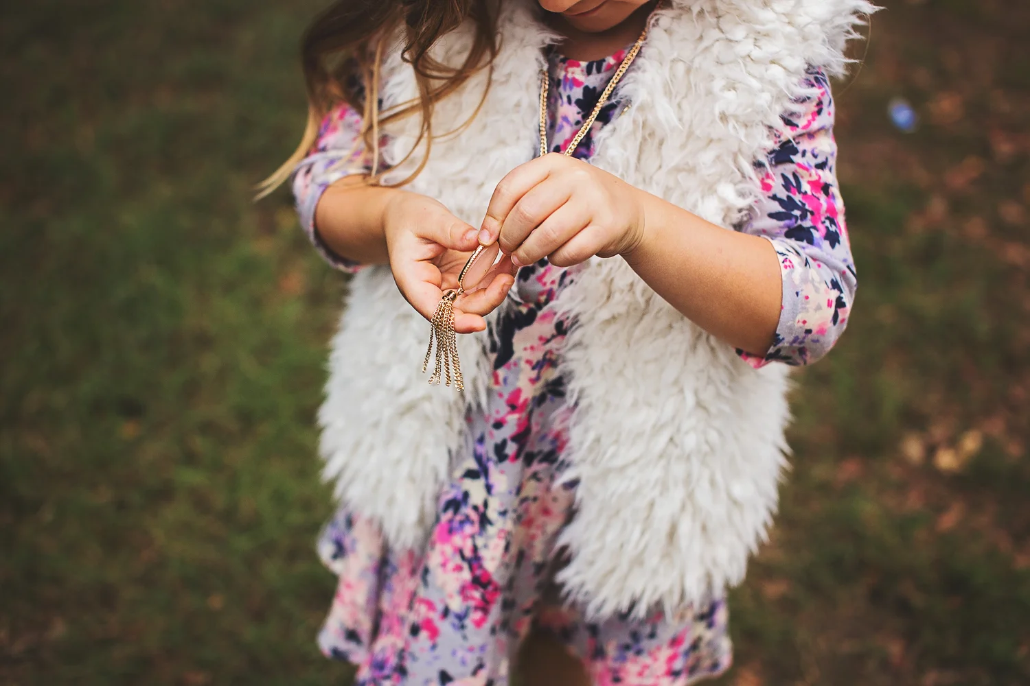 Young girl plays in field during Dallas Fort Worth family photography session.