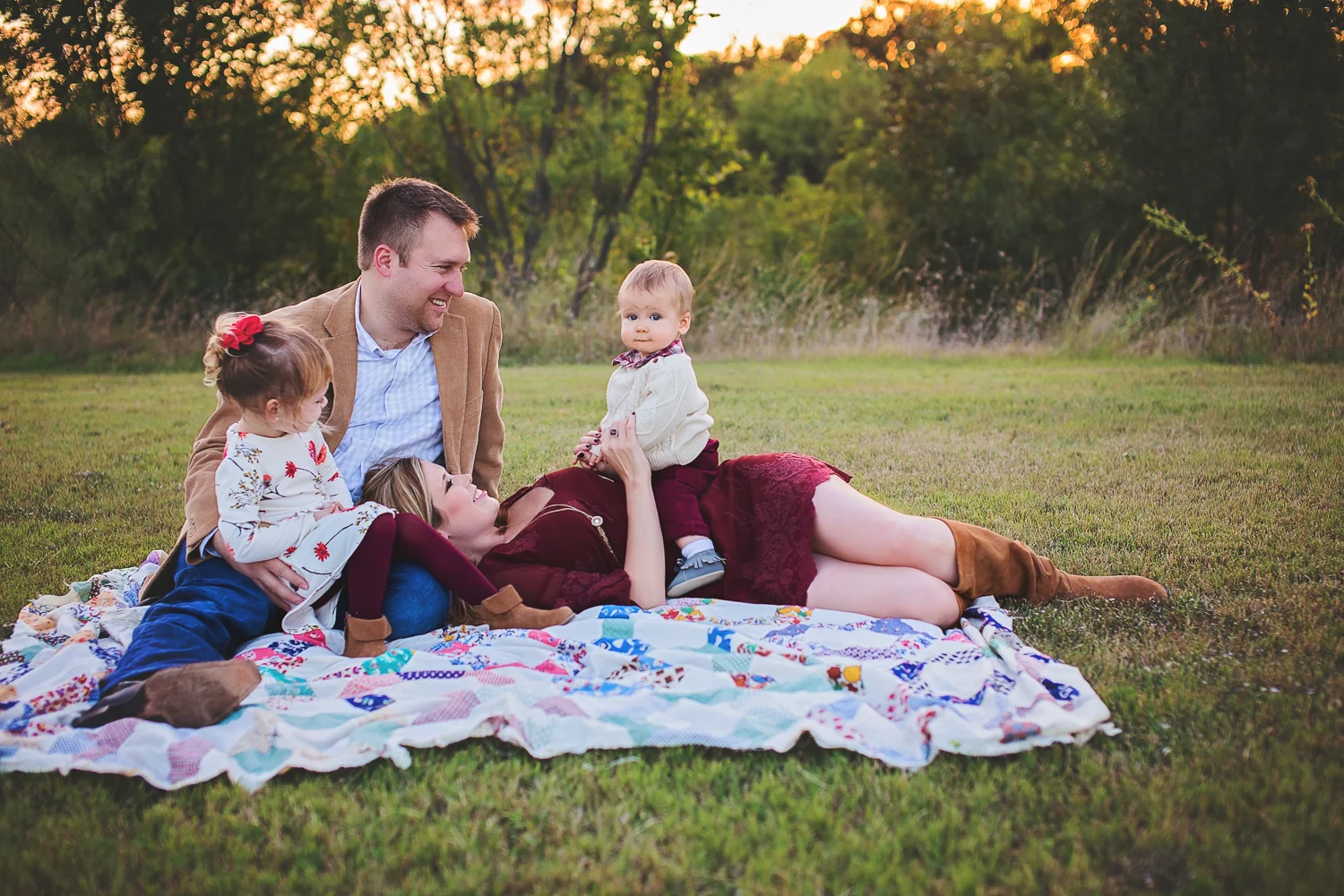 Dad smiles down at son during family portrait session in Dallas Fort Worth, Texas.