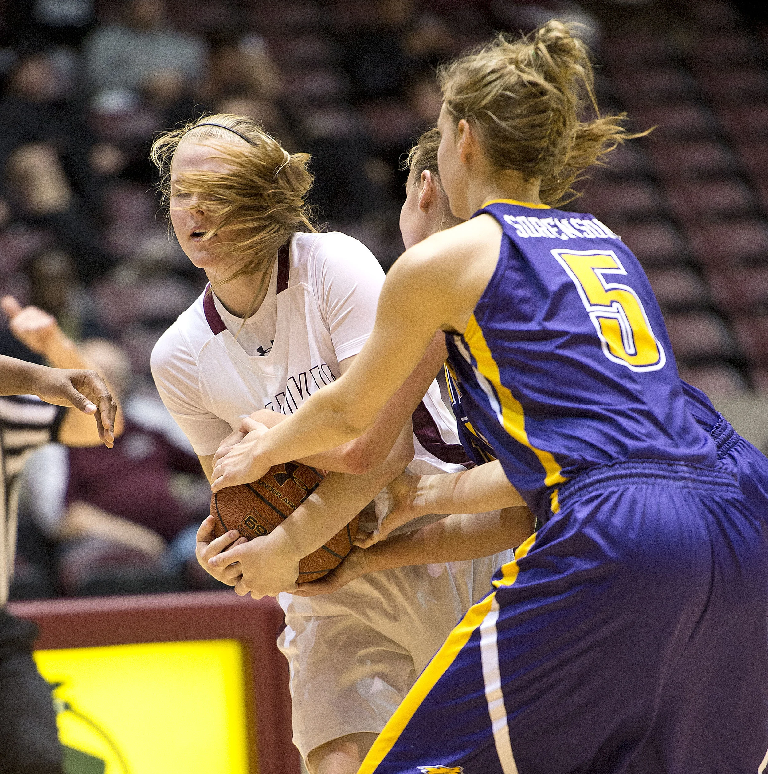 Salukis guard Carlie Corrigan wrestles away the ball while being double teamed by Northern Iowa's Stephanie Davidson and Amber Sorensen.