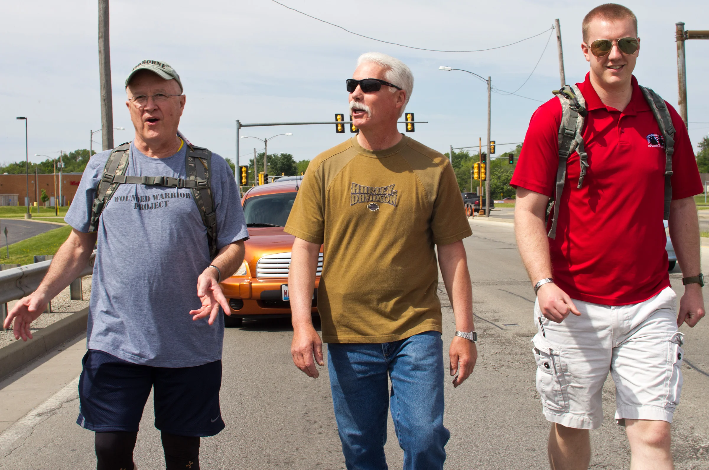 From left to right, Ron Stephens, Scott Hartman and Cody Floyd, all veterans, converse as they begin their journey towards Elwood, Ill., on May 24 in Decatur, Ill.