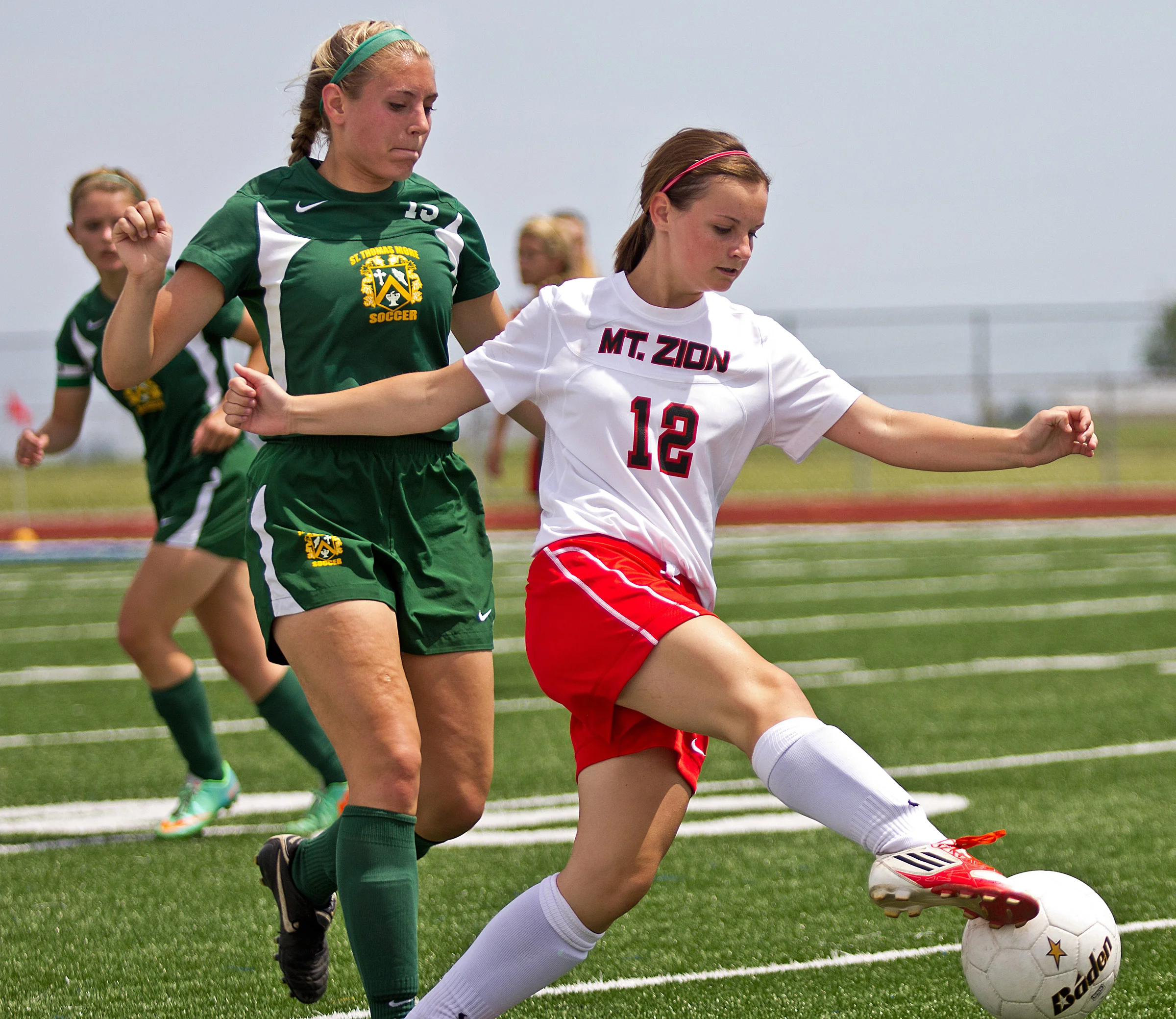 Mount Zion's Jenna Platzbecker keeps the ball in play during the sectional championship game against Champaign Saint Thomas More on May 24 at Walter Boyd Field in Maroa, Ill. The Braves lost to the Sabers 3-2 as Champaign Saint Thomas More claimed their first sectional title in program history.