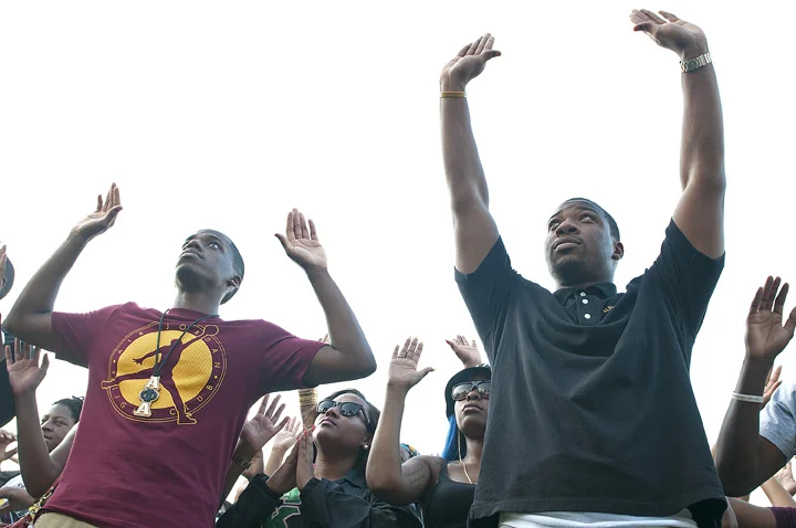 SIU students participate in the "Hands Up, Don't Shoot" rally on Aug. 18 in front of Grinnell Hall. The rally shed light on the recent violence outbreaks in Ferguson, Mo., and the death of 18-year-old Michael Brown, who was shot by a St. Louis County police officer on Aug. 9.