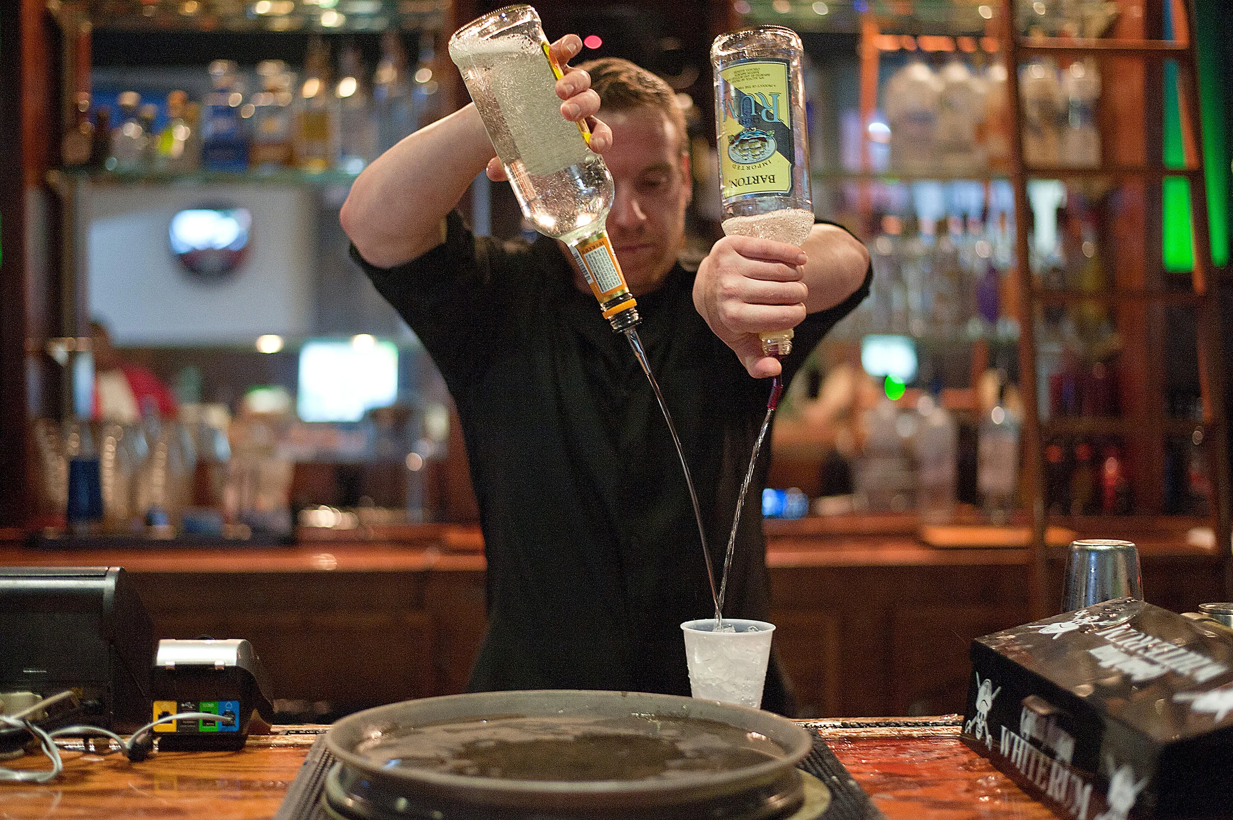 Jon Hall, of Sesser, Ill., mixes a drink on Sept. 20 at Saluki Bar N' Grill in Carbondale, Ill. The bar changed its age limit to 21 and up on Sept. 14.