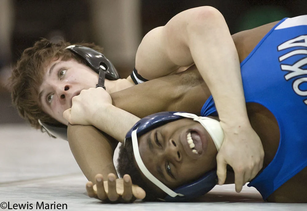 Carbondale Community High School's Will Meador keeps his eyes on the clock while holding down Cahokia High School's Deairis Tipler during a first round match of the 132-pound tournament on Jan. 11 at Carbondale Community High School in Carbondale, Ill.