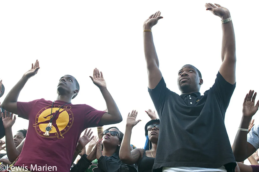 SIU Carbondale students and community members pose for a "Hands Up, Don't Shoot" group photo on Aug. 18 in front of Grinnell Hall.