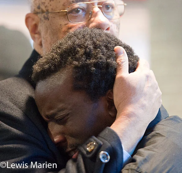 The Rev. Joseph Brown, a SIU Carbondale professor of Africana Studies, consoles student Ben Smith during a "die-in" demonstration on Dec. 9 at the Student Center.