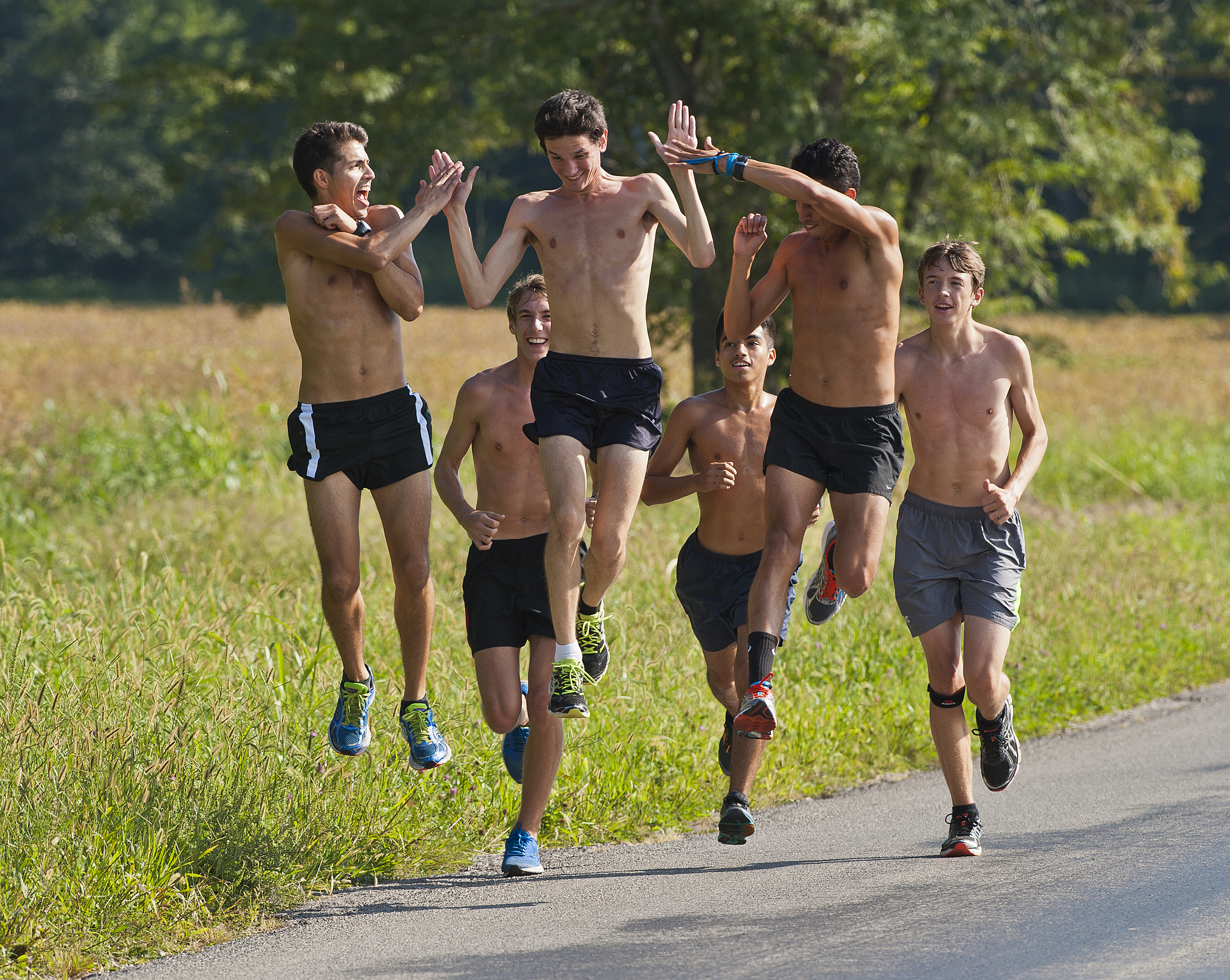  Southern Illinois men’s cross country team members Oscar Medina, Evan Ehrenheim and Juan Carrera share a high five on Wednesday, Sept. 17, 2014, during practice along Dogwood Road in Carbondale, Illinois. The cross country men’s and women’s teams ar