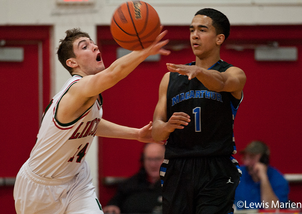 Lincoln's Payton Ebelherr (14) tries to pick off a pass from MacArthur's Dallas McClain (1) during the Generals' regional championship game with the Railers at Mount Zion High School in Mount Zion, Ill. MacArthur won 57-38.