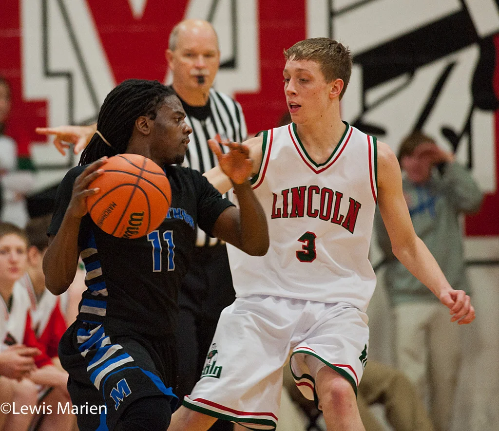MacArthur's Shawntrez Spates (11) tries to get around Lincoln's Will Cook (3) during the Generals' regional championship game with the Railers at Mount Zion High School in Mount Zion, Ill. MacArthur won 57-38.