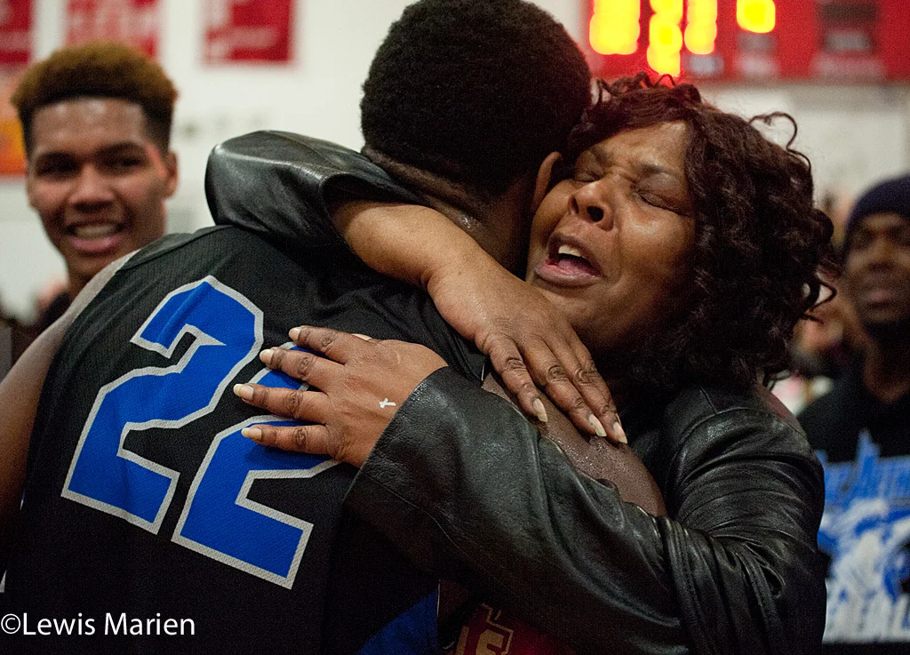 MacArthur's Kamari Jones (22) receives a hug after the Generals' regional championship game with the Lincoln Railers at Mount Zion High School in Mount Zion, Ill. MacArthur won 57-38.