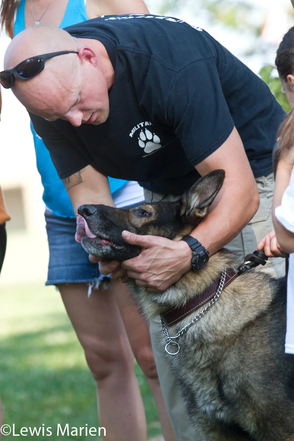 Chris Spears, of Knoxville, Ill., shares a moment with his dog Rossi, a 9-year-old Czech shepherd, during a welcome home ceremony for the two on Sept. 4 at the Connie Nott Canine Area at Inbinder Park in Galesburg, Ill. Spears, who is currently a police officer in Abingdon, Ill., reunited with Rossi at the ceremony, who both served overseas in Iraq and Afghanistan. Rossi is a former Navy K-9.