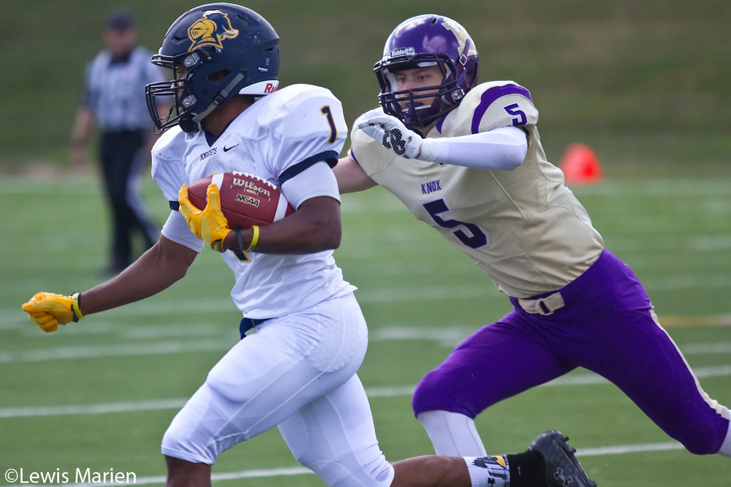 Carleton College's Chris Madden (1) runs with the ball as Knox College's Sam Coffey (5) closes in during the Prairie Fire's home opener against the Knights on Sept. 12 at Knox College's Stisser Field. The Prairie Fire defeated the Knights 23-20.