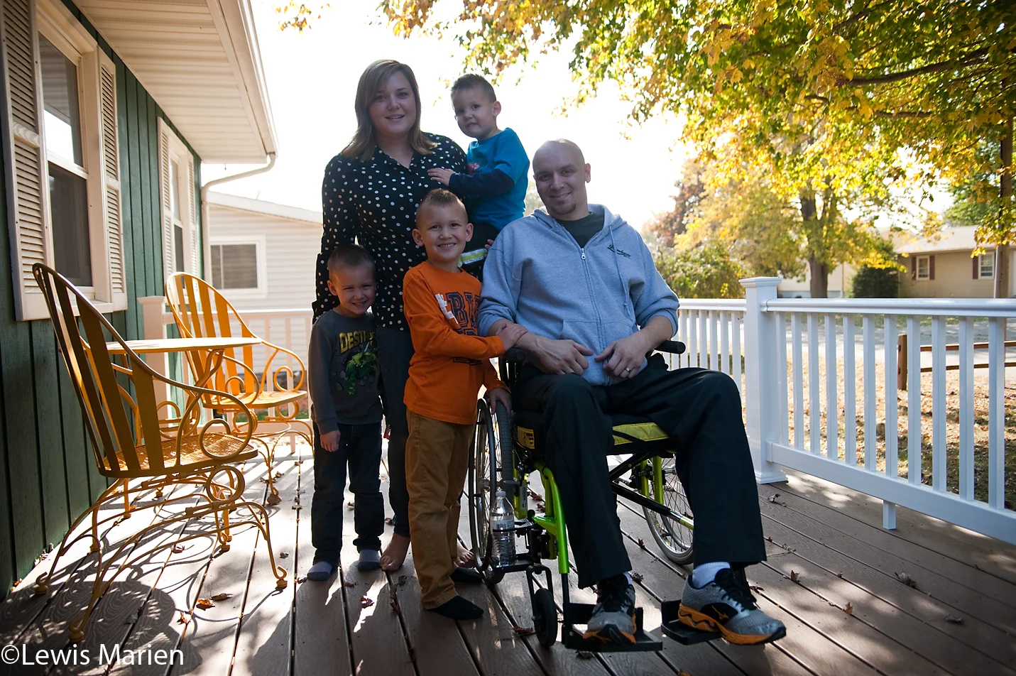 Jon Rekash, center right, of Abingdon, Ill., sits for a photo with his family on the porch of their house. On June 6, 2015, Jon, who had just became a full-time police officer with the Abingdon Police Department, went out one night to ride his motorcycle. Later that night, he woke up laying in a ditch and couldn't move. The accident has left him in a wheelchair but he says his faith in God and Jesus Christ has kept him alive, and the community of Abingdon has been supportive for him as he continues to recover.