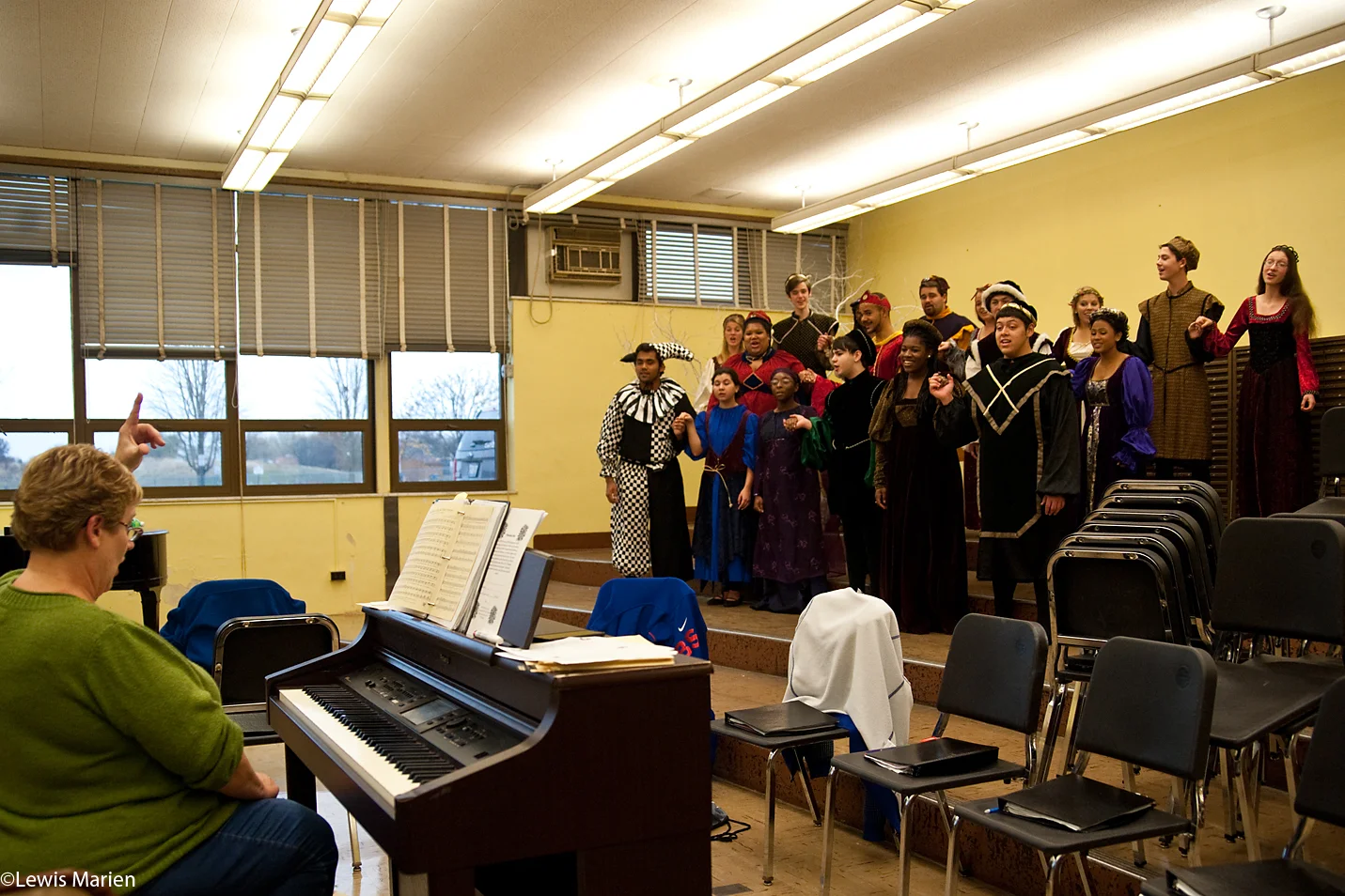 Paula Helle, left, leads members of the Galesburg High School choir in rehearsal Nov. 11. The choir has been rehearsing for its annual Madrigal Dinner held in December.