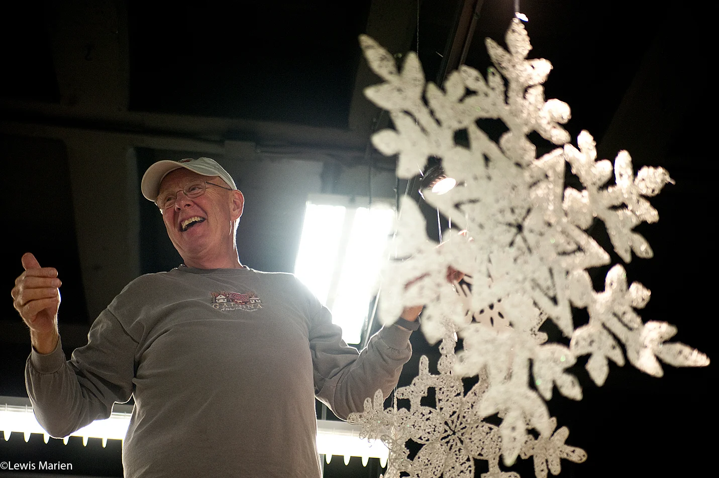 Tom Egan, of Galesburg, Ill., shares a laugh with volunteers as he hangs snowflakes inside the Discovery Depot Children's Museum in Galesburg, Ill., Nov. 30 in preparation for the annual Festival of Trees event held on the first Thursday in December.