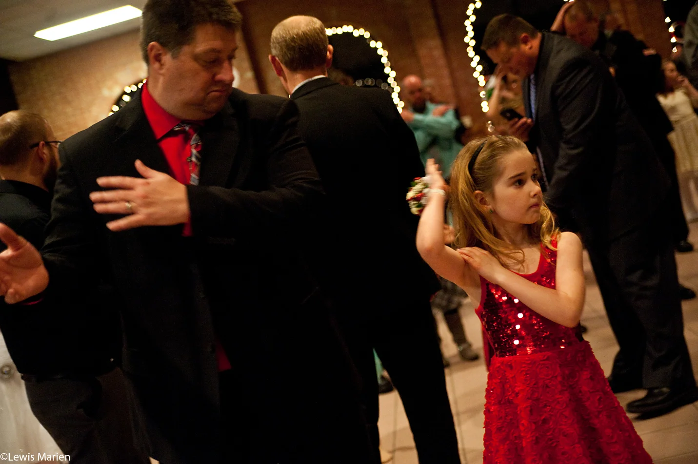 Richard Hogan, of Galesburg, Ill., dances to the "Macarena" with his daughter Alexis, 7, during the 27th annual Daddy-Daughter Candyland Ball Dec. 2 at the Lake Storey Pavilion in Galesburg, Ill.