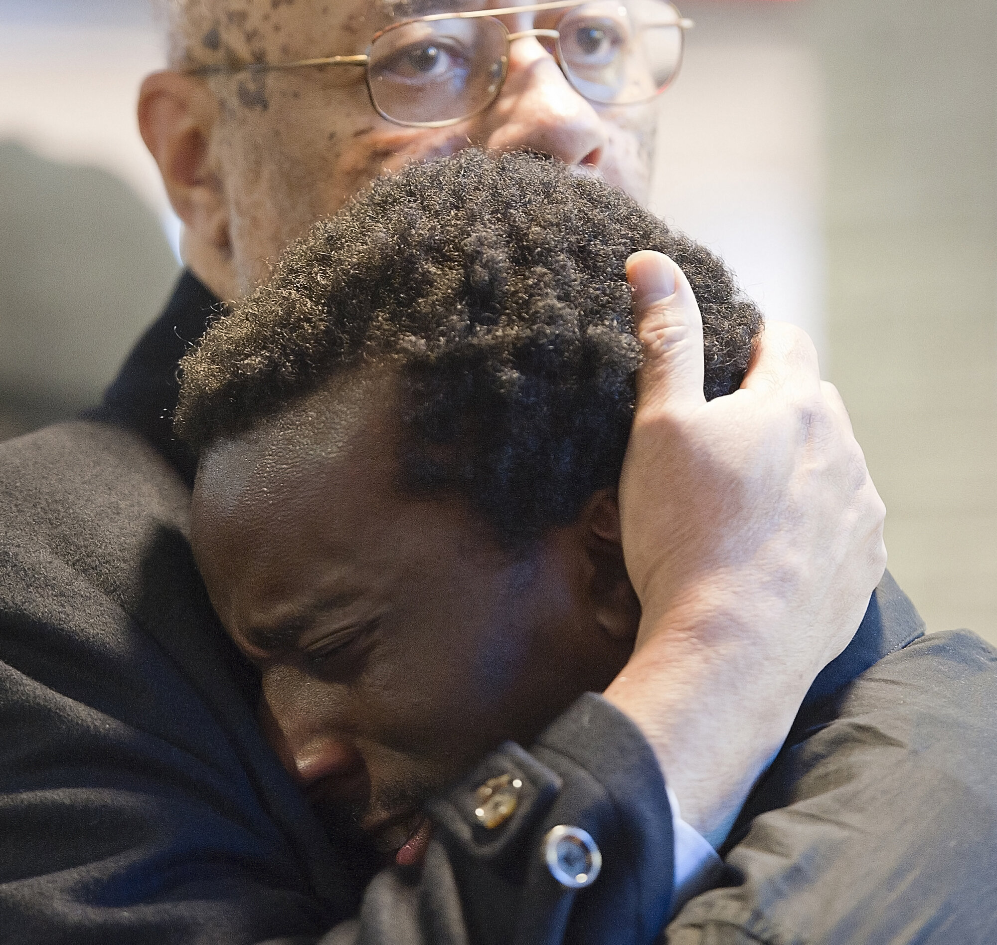  The Rev. Joseph Brown, a Southern Illinois University Carbondale professor in Africana studies, consoles student Ben Smith during a die-in demonstration on Tuesday, Dec. 9, 2014, in Carbondale, Illinois. Smith was one of several speakers during the 