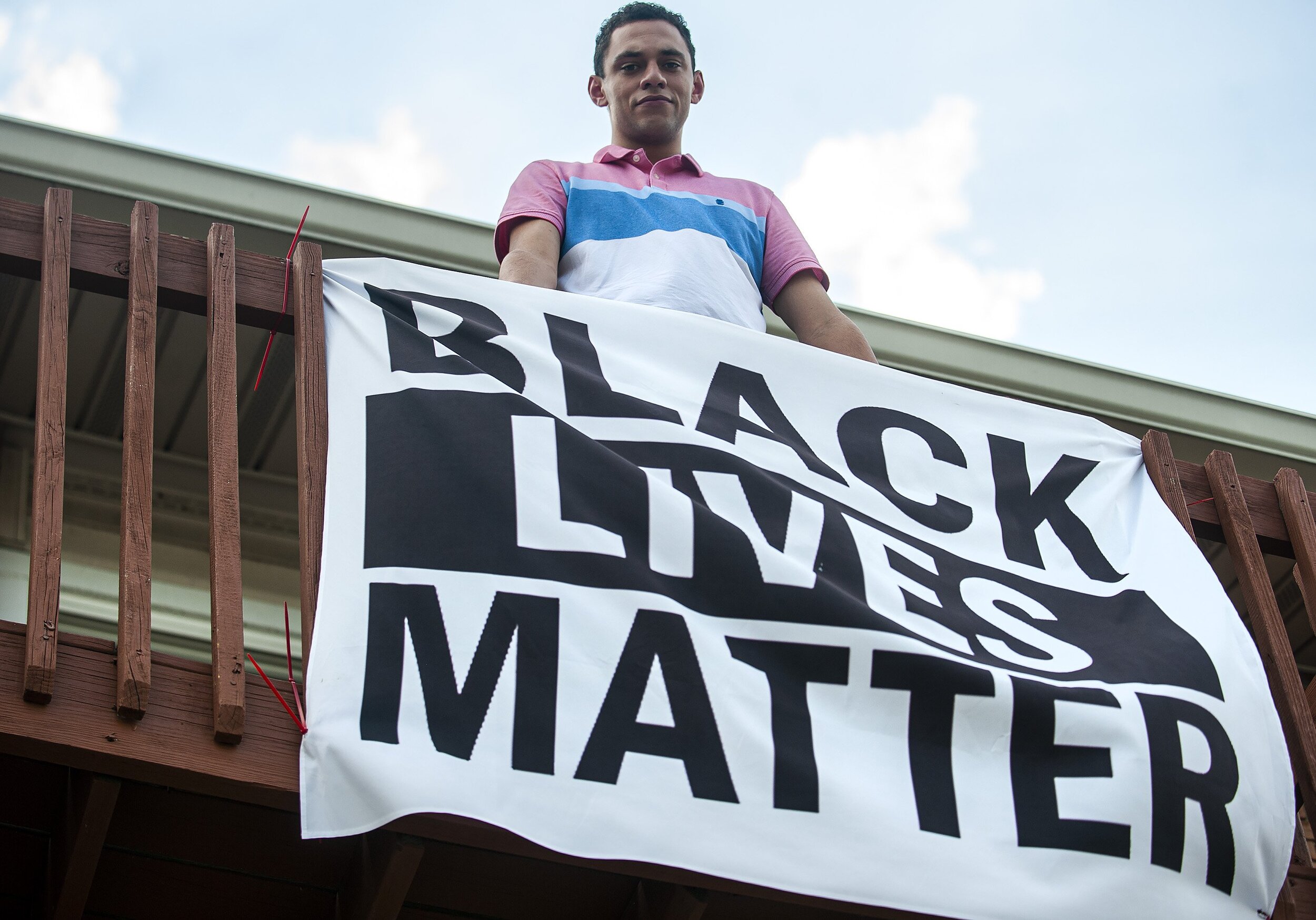  Donavon Burton displays his “Black Lives Matter” flag on the balcony of his apartment in Bloomington, Illinois. Burton has been served an eviction notice from his landlord, First Site Apartments, because he has refused to take down the flag. 