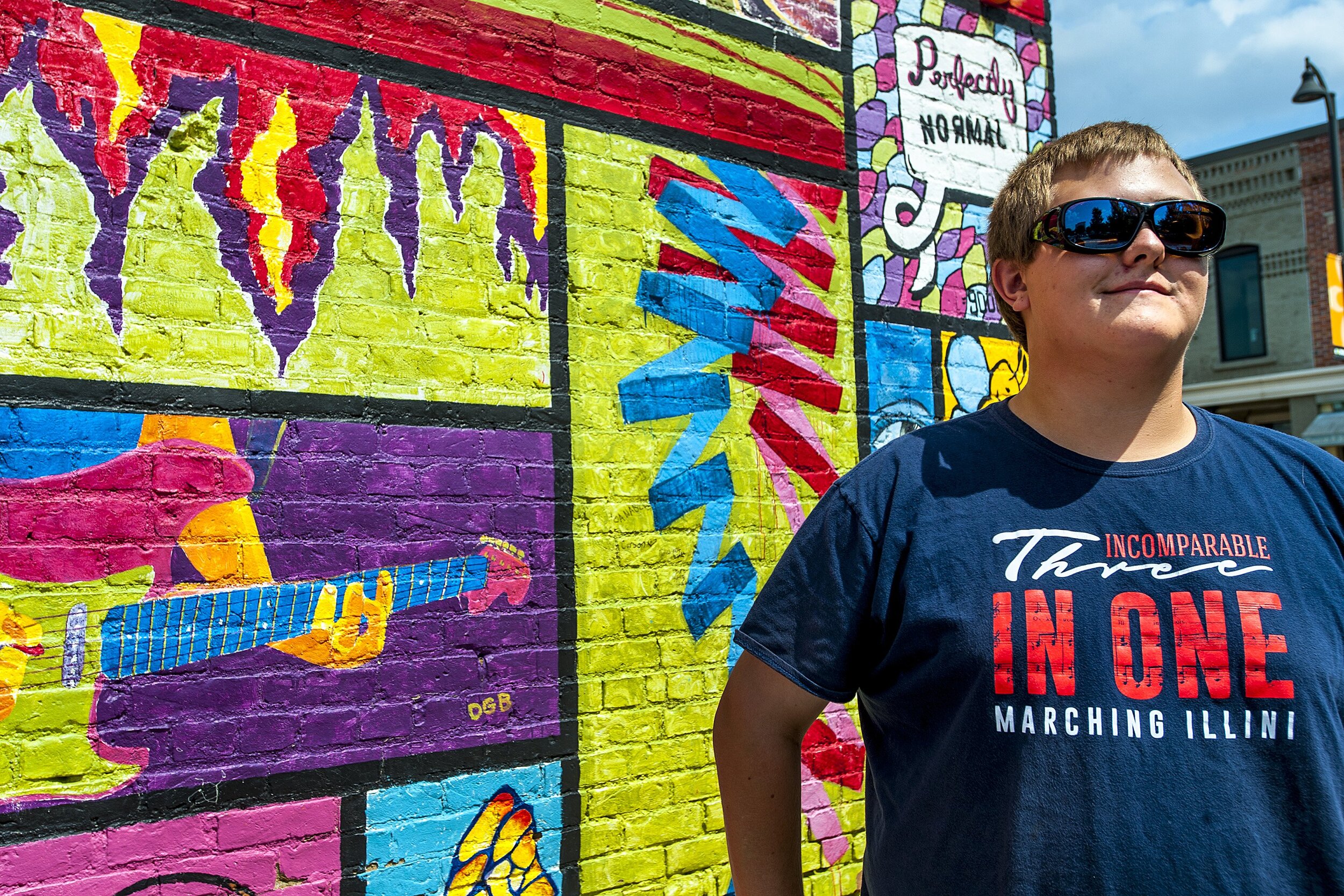  Zach Craig tries on his new Enchroma glasses while visiting a mural in Normal, Illinois. Craig is colorblind and realized it when he was in his third grade art class as they were studying the color wheel. “I could just distinguish a few colors. I co