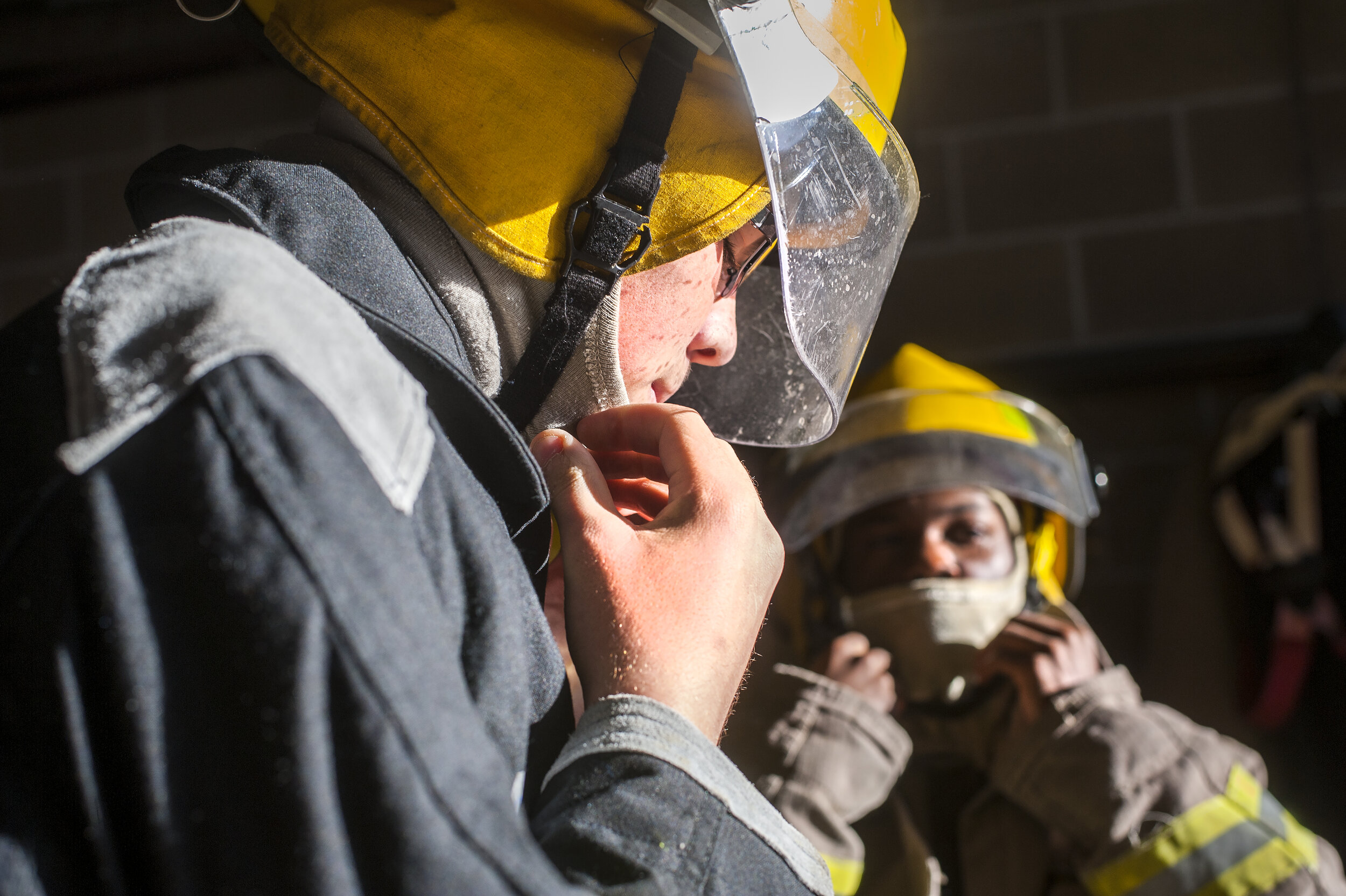  Richwoods High School student JJ Williams, left, and Peoria High School student Keelan Bailey put on firefighter gear during their hands-on training Sunday, Oct. 9, 2016, at the Peoria Fire Training Academy, 7130 N. Galena Road. 