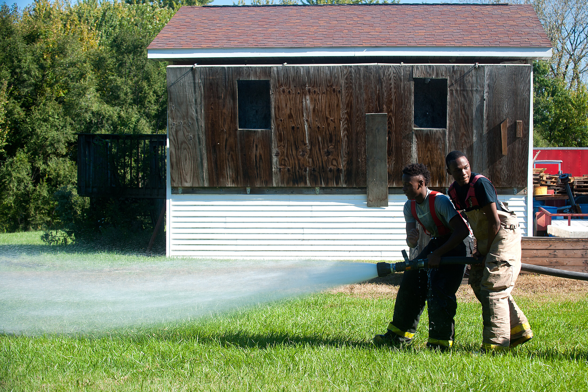  Peoria High School students Eryon Byrd and Keelan Bailey work together to operate a fire hose during training Sunday, Oct. 9, 2016, at the Peoria Fire Training Academy, 7130 N. Galena Road. 