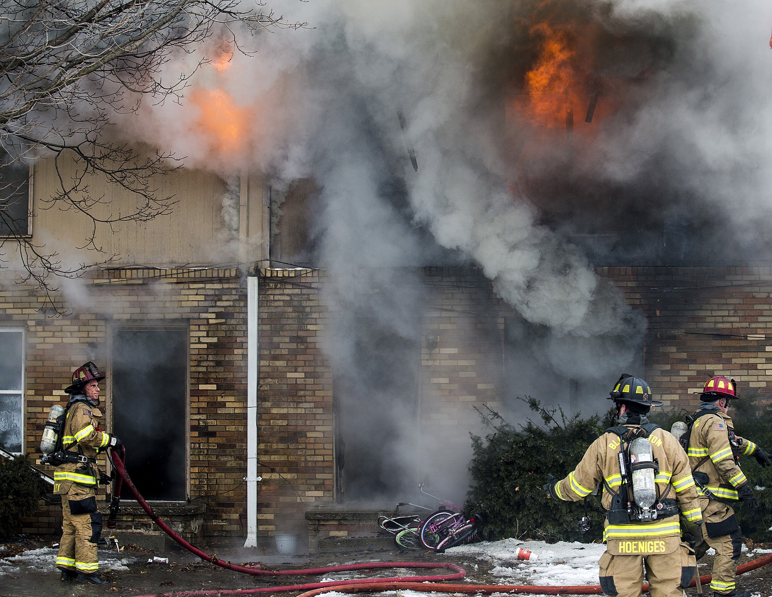  Firefighters plan their attack on a structure fire Saturday, Feb. 10, 2018, at a two-story, 12-unit apartment complex on Gettysburg Drive in Bloomington, Illinois. The fire was reported at 3:20 p.m., and one firefighter was injured during response. 