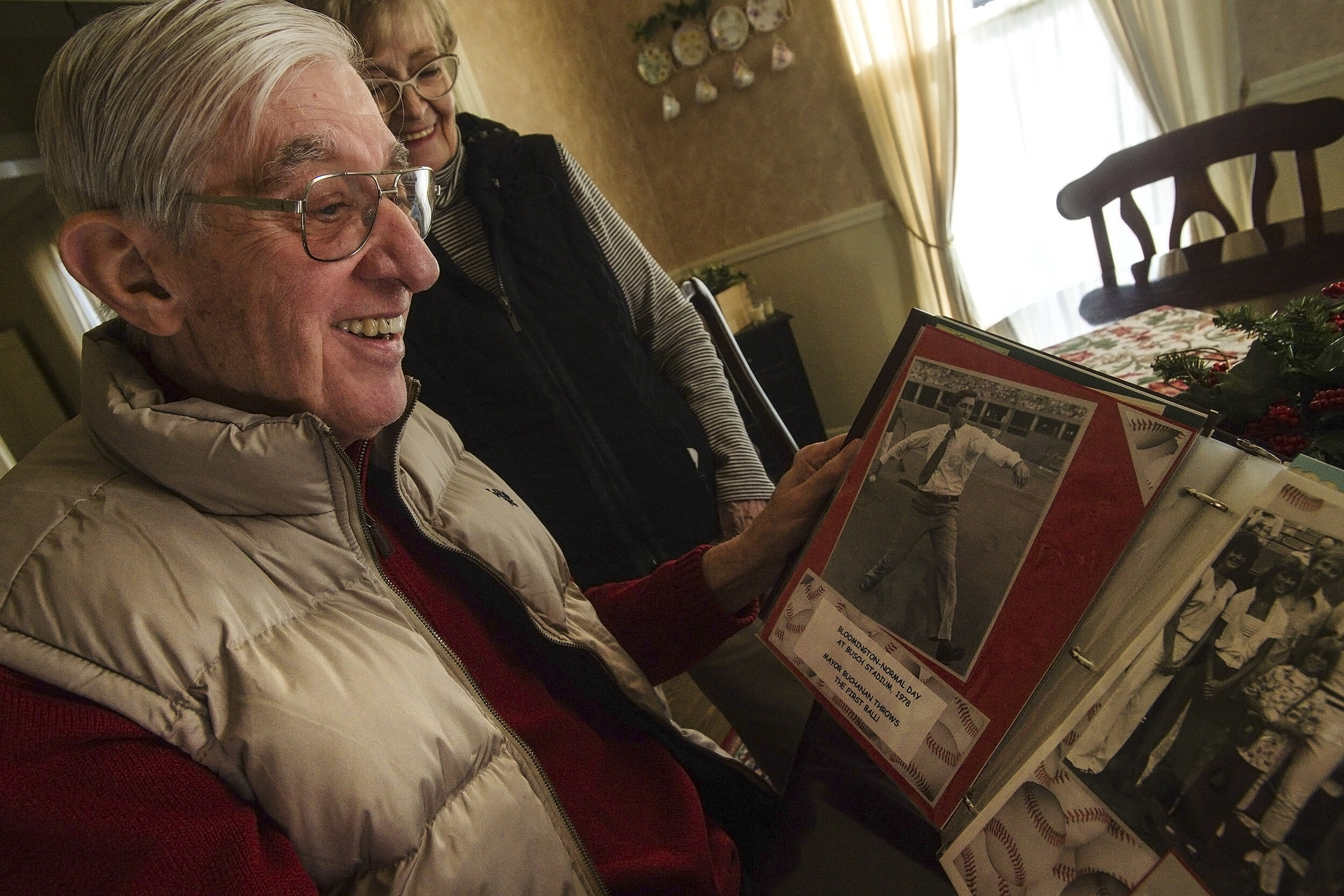  Rich Buchanan and his wife, Judy, react as they find a photo of a younger Rich in a scrapbook on Friday, Feb. 2, 2018, at their home in Bloomington, Illinois. Judy Buchanan said the scrapbook allows them to have fun reminiscing and celebrating what 