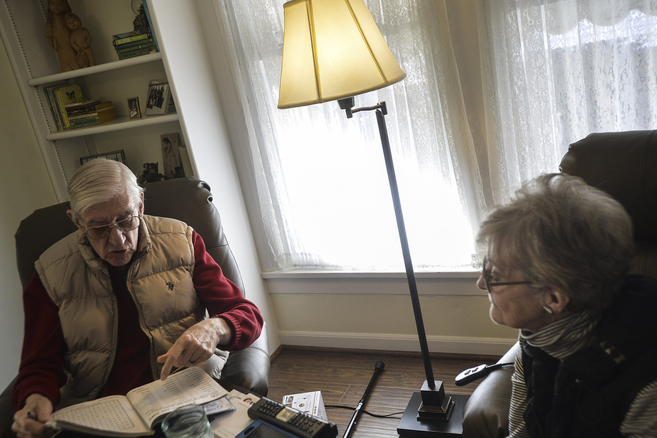  Rich Buchanan works a word search as his wife, Judy, observes on Friday, Feb. 2, 2018, at their home in Bloomington, Illinois. “They are kind of fun,” Rich said of word searches. “But after 30 to 45 minutes of that, I’m exhausted.” 