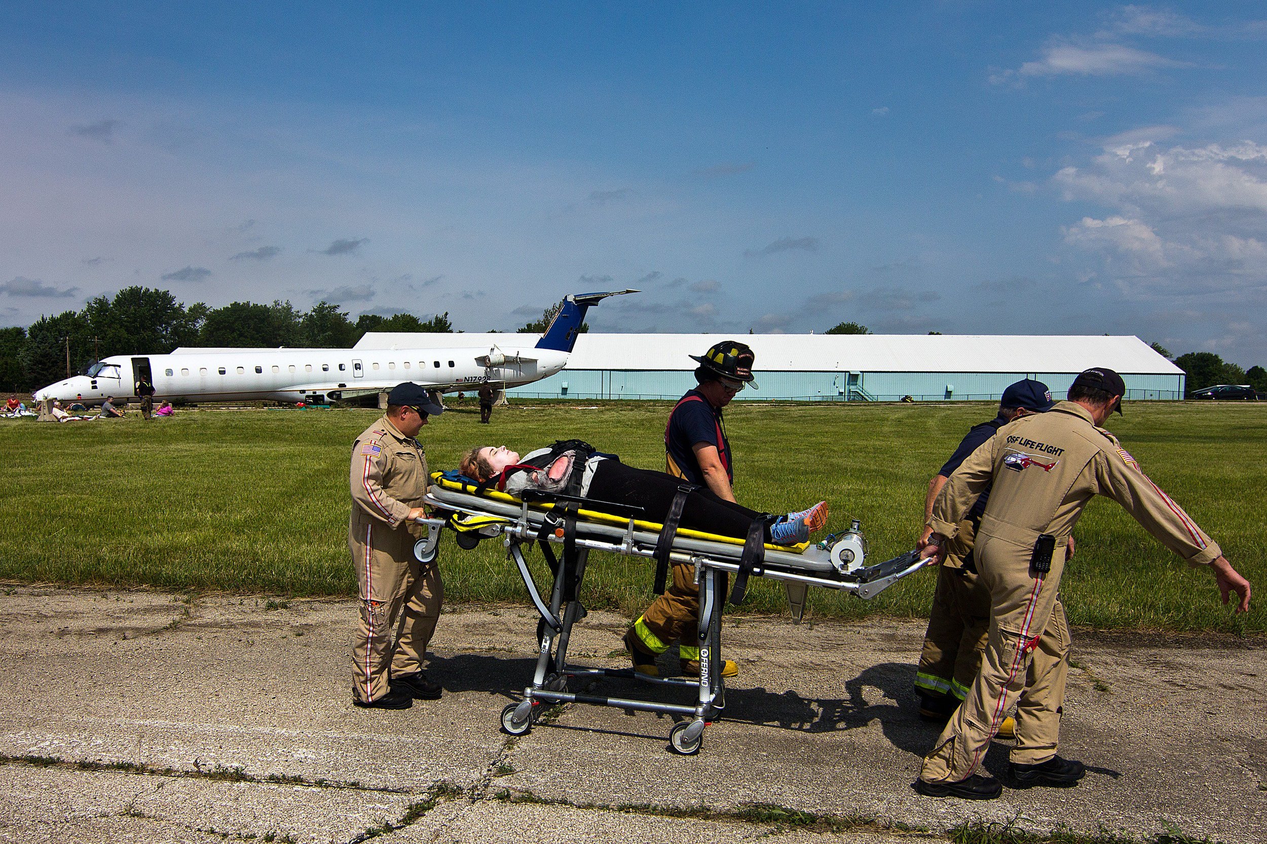  Emergency personnel wheel a “victim” away from a mock airplane crash during a full-scale emergency drill Saturday, June 22, 2019, in Bloomington, Illinois. Central Illinois Regional Airport has to complete the drill, implementing its Airport Emergen