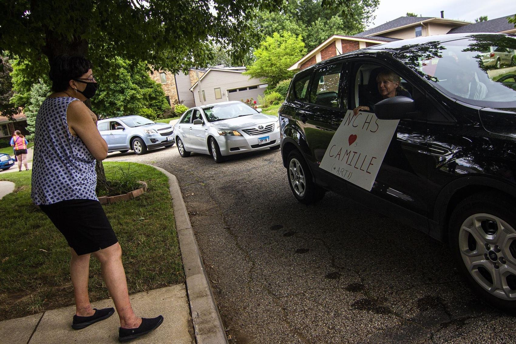  Camille Taylor, left, greets a passerby Friday, July 31, 2020, outside her home in Bloomington, Illinois. Earlier in the month, Camille and her husband, Art Taylor, were the targets of a disagreement in their neighborhood, so friends and colleagues 
