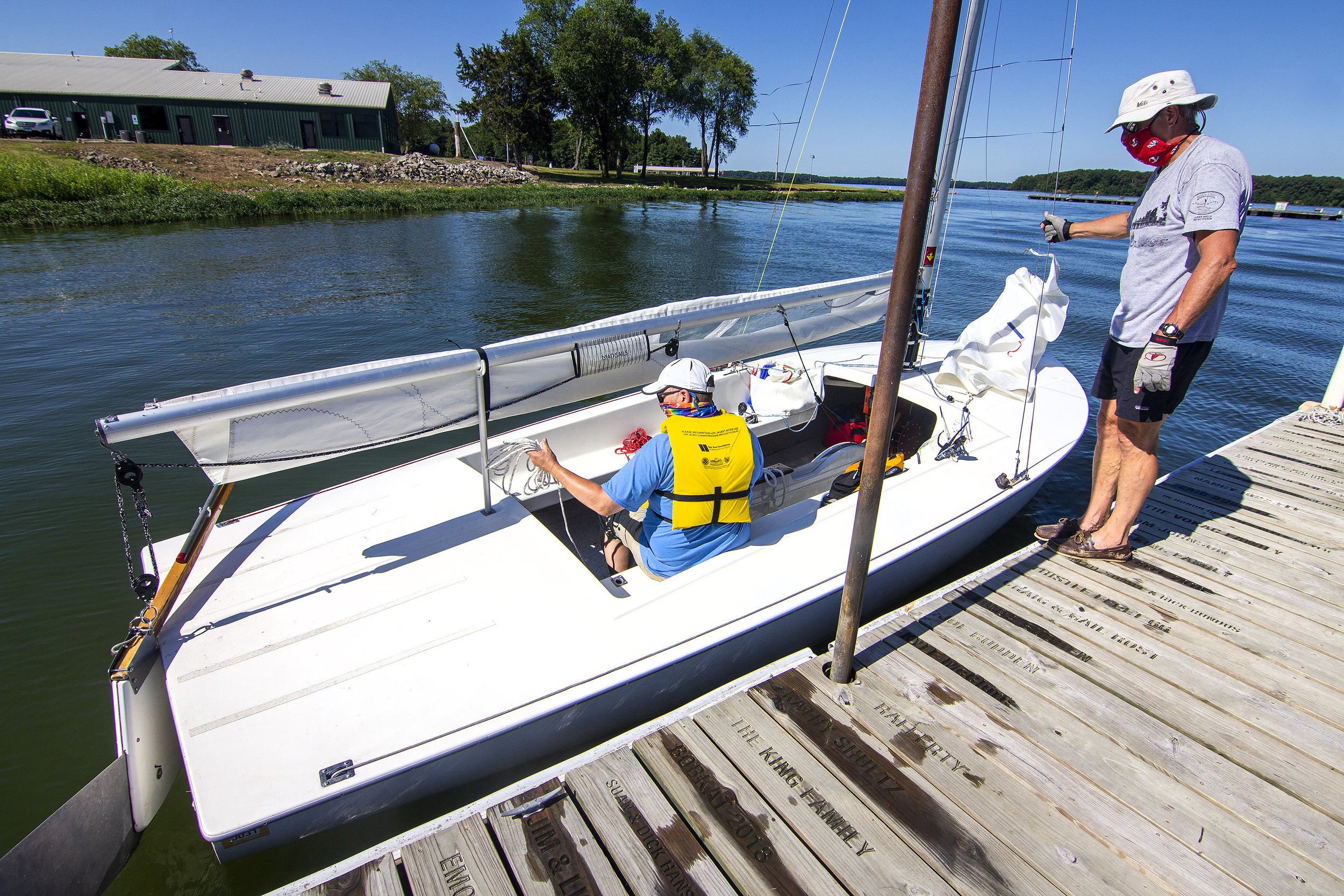  US Sailing-certified instructor Jim Colegrove, right, observes as student Alan Schuele makes preparations during a lesson Sunday, July 12, 2020, on Clinton Lake. The lessons are offered by the Clinton Lake Sailing Association. 