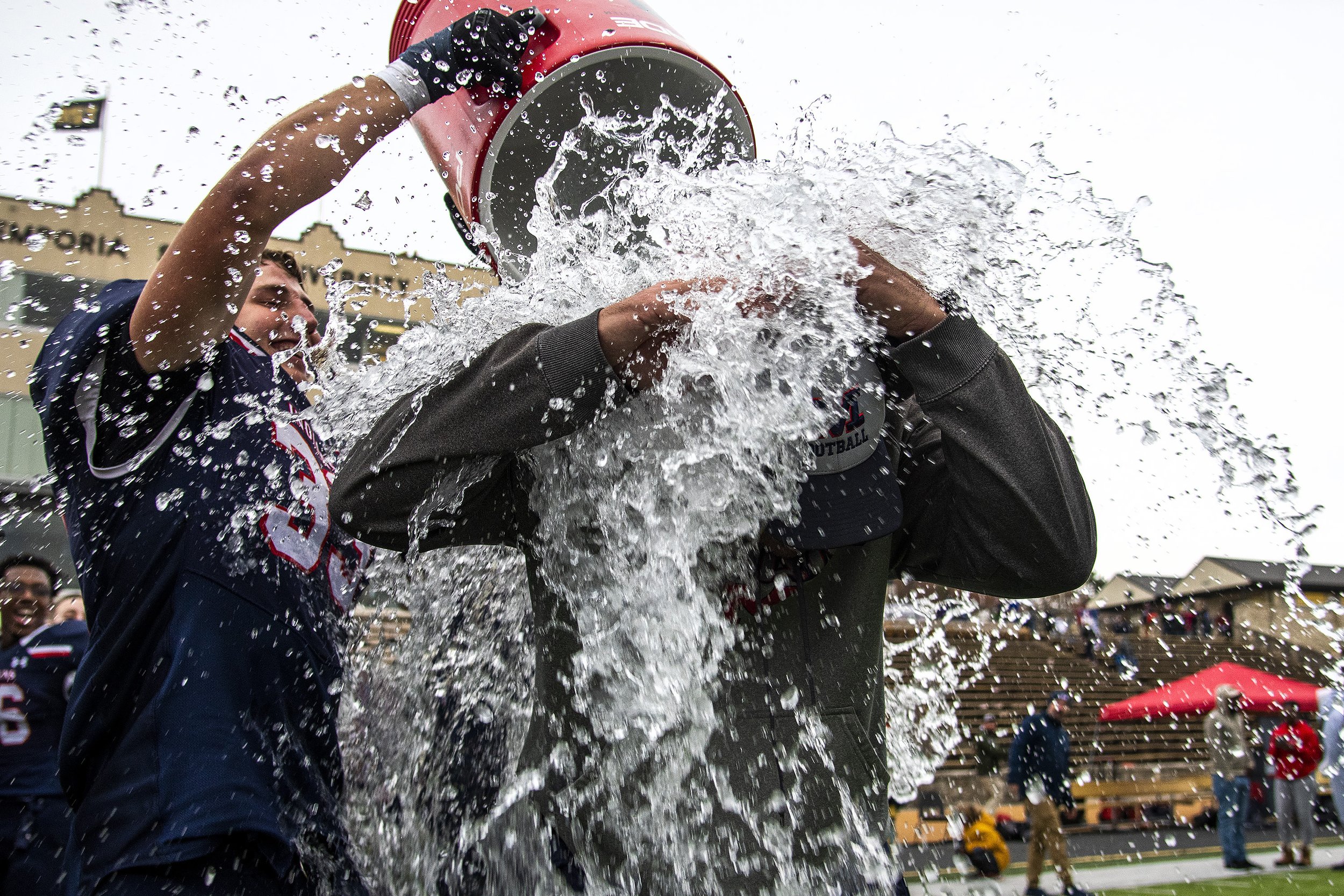  Manhattan High School head football coach Joe Schartz is given an ice bath by linebacker Ben Irvine, left, after the Indians’ 21-20 double-overtime KSHSAA 6A state championship victory over Gardner Edgerton High School on Saturday, Nov. 26, 2022, at