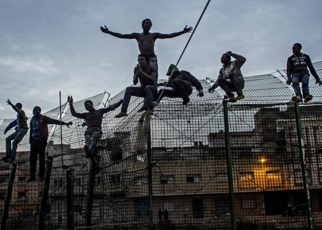 The Wall of Europe, Spain, 2014 Young Africans try to climb the double fence that separates Africa from Europe, near Beni Enza on the border of Spanish exclave Melilla Photograph: Sergi Cámara