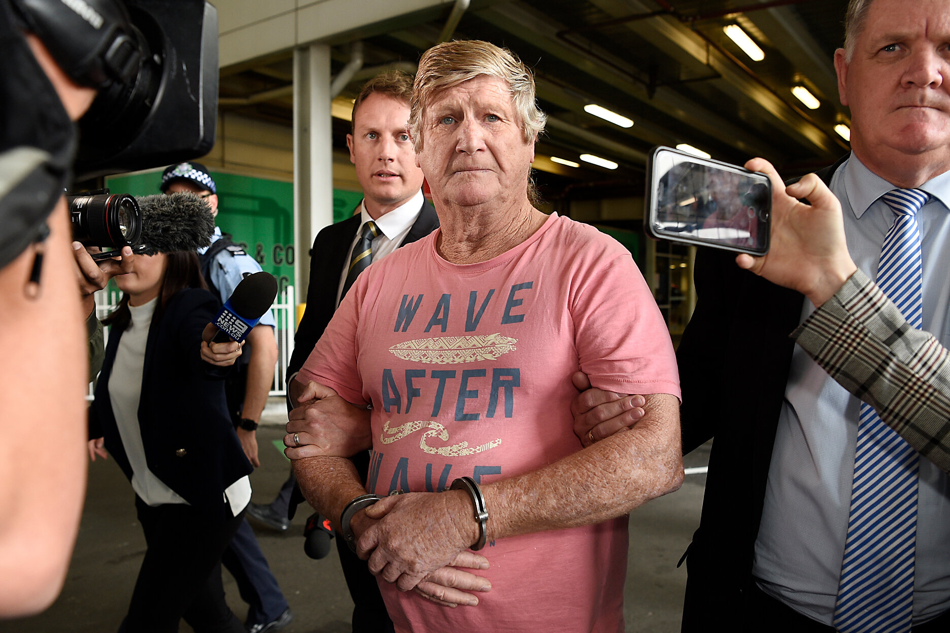  John Bowie is seen arriving via police escort at Sydney Domestic Airport in Sydney, Saturday, October 5, 2019. John Bowie has been extradited from Brisbane to Sydney after being arrested in relation to the cold case murder of his wife Roxlyn Bowie 1