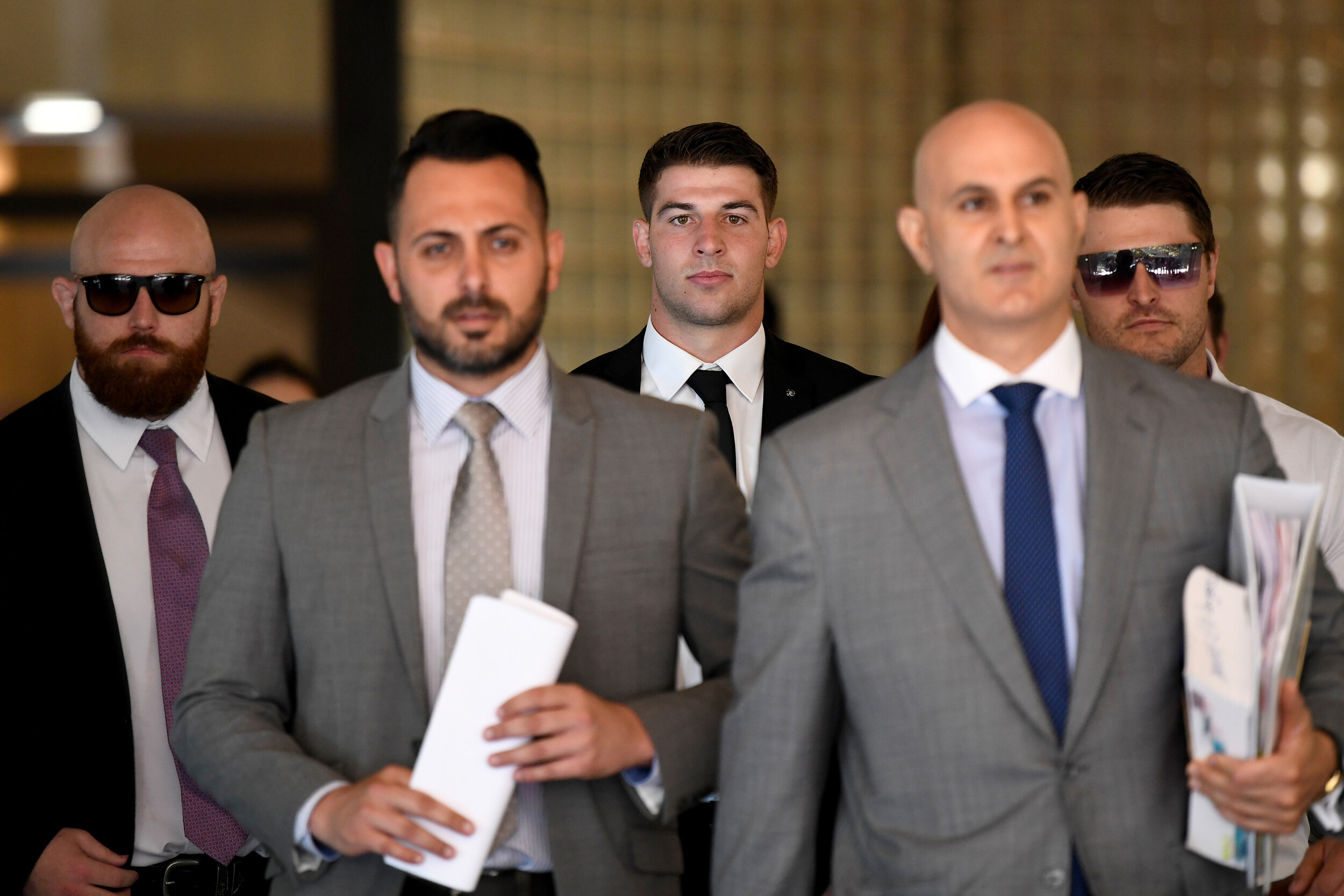  NRL player Curtis Scott (centre) is seen leaving Downing Centre Local &amp; District Court ins Sydney, Friday, January 31, 2020. Curtis Scott has been charged with assaulting police. (AAP Image) 