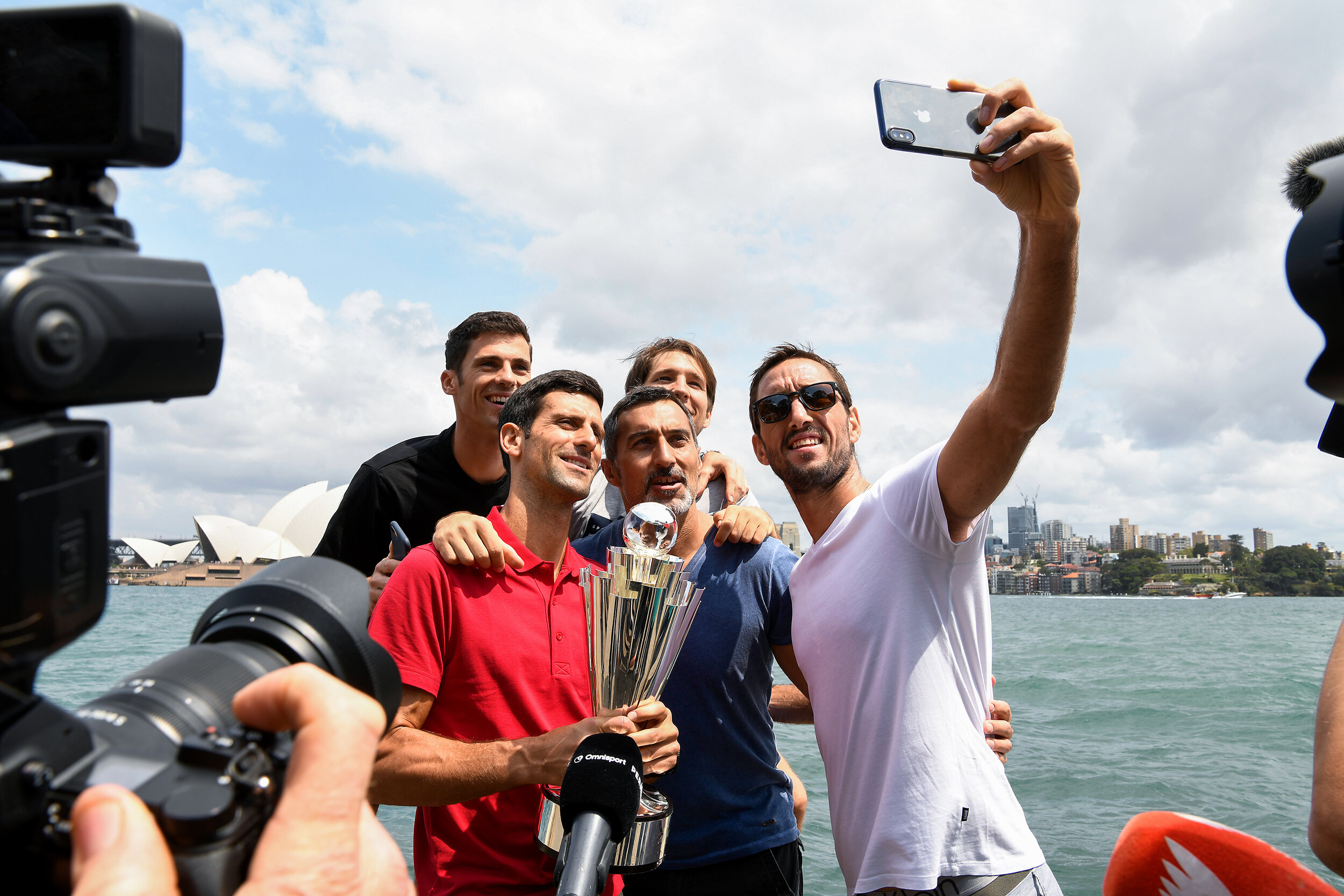  (L-R) Team Serbia tennis players Nikola Milojevic, Novak Djokovic, captain Nenad Zimonjic, Dusan Lajovic and Viktor Troicki pose for a photograph with the ATP Cup Champions trophy at Mrs Macquaries Point in Sydney, Monday, January 13, 2020. (AAP Ima