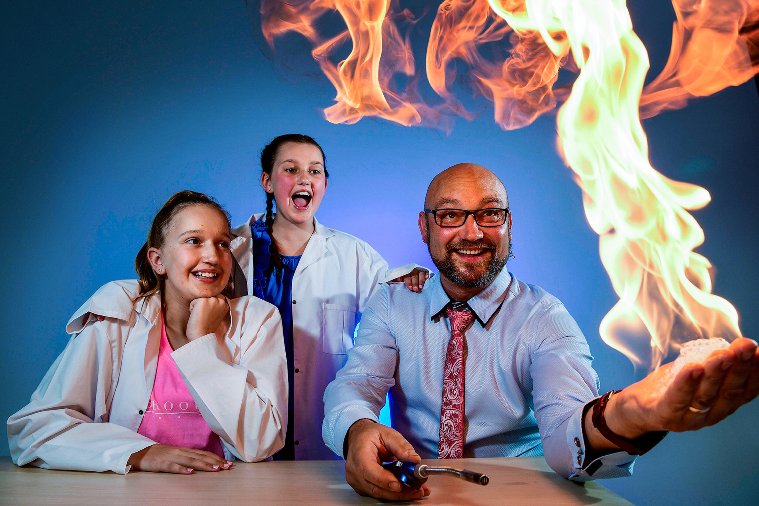  4.1.19 - Sisters Lilli, 12, and Mia Bennett, 10, watch on as Lee Harrison from STEMplay SA does a science demonstration with fire, in Adelaide's CBD. Lee will take part in this year's Tour Down Under's 'Science with Santos' at the the Tour Village, 