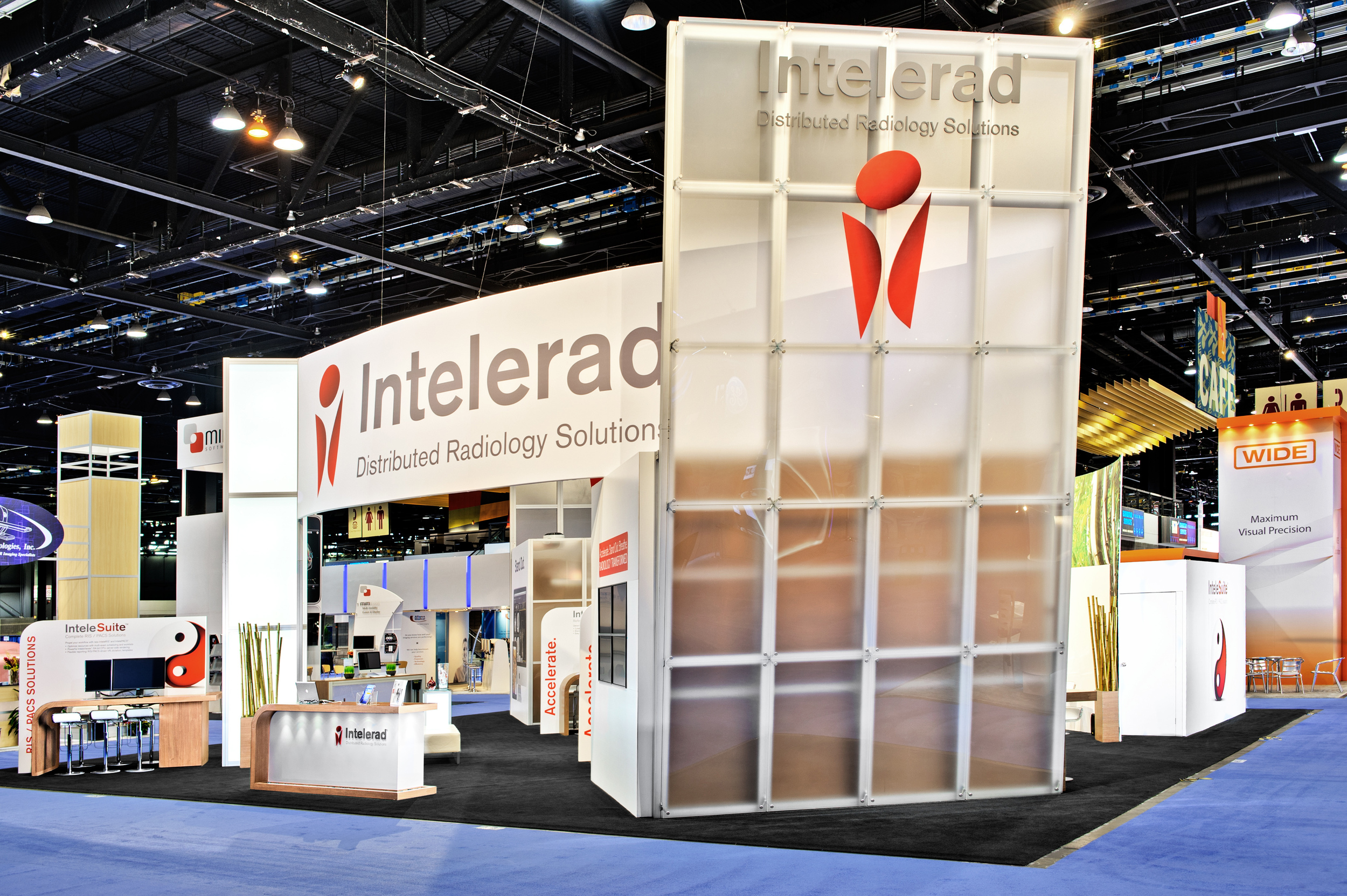 Intelerad's trade show booth rental with a photo of the custom acrylic slanted wall
