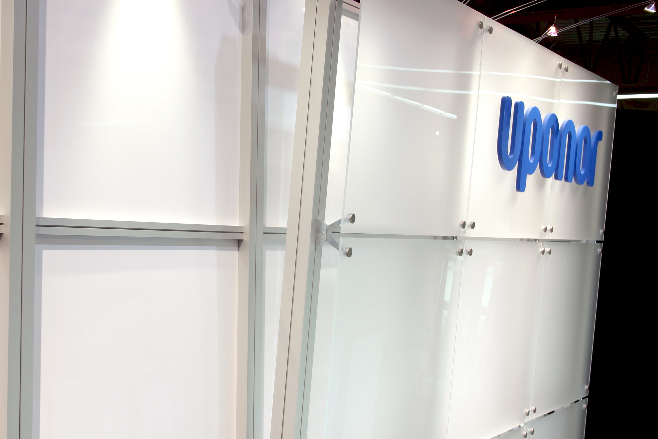 This modern 10' x 20' booth showcases product on glowing pedestals and a clean backwall highlighting their branding