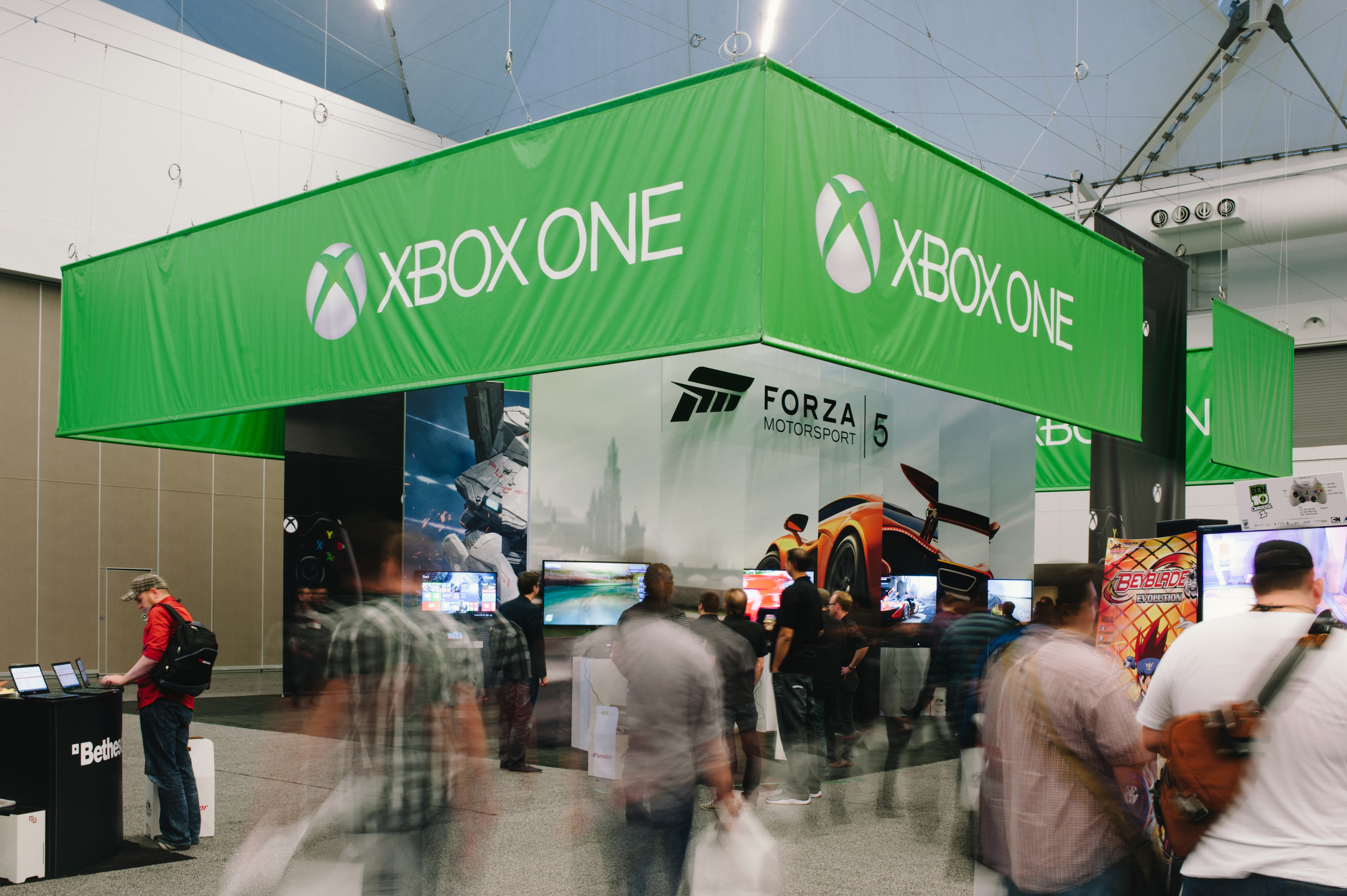 A large hanging banner, over-sized graphics, and integrated AV combined with custom pedestals for the Xbox One launch event at EB Games