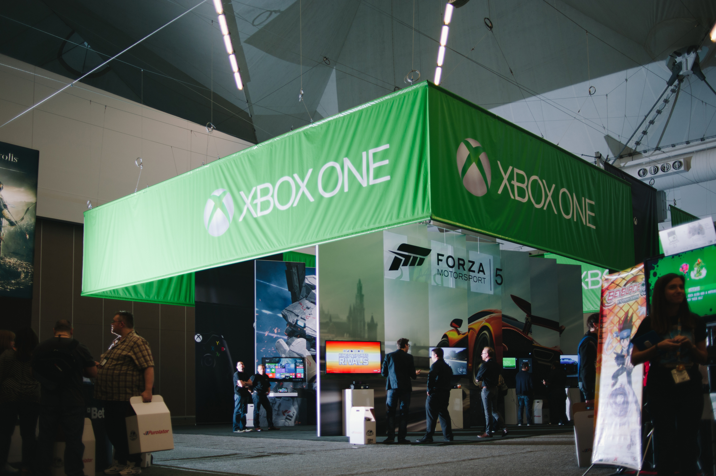 A large hanging banner, over-sized graphics, and integrated AV combined with custom pedestals for the Xbox One launch event at EB Games