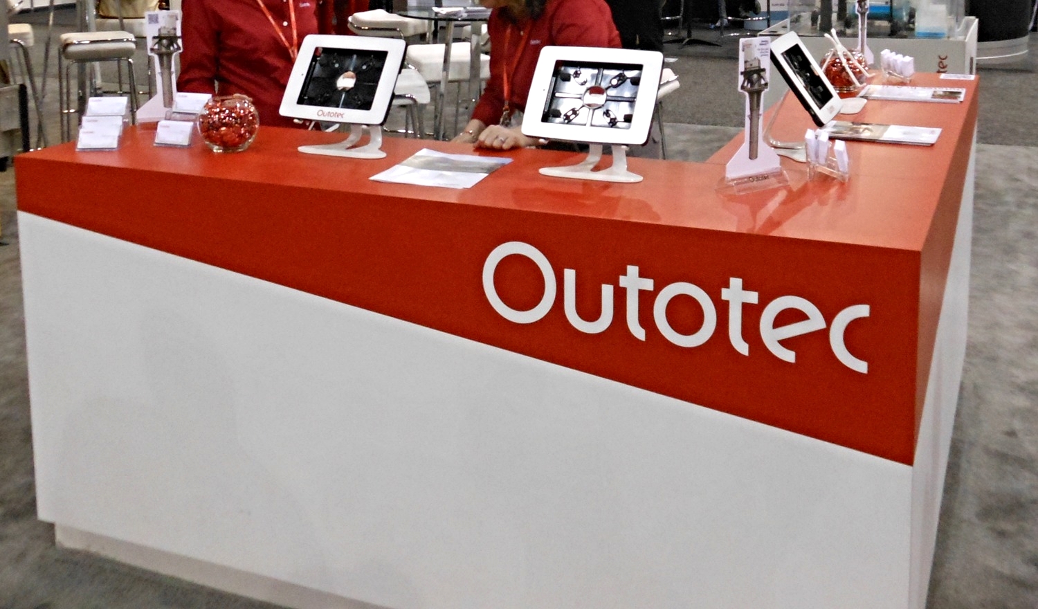 Outotec's exhibit featured a large hanging sign, custom millwork and modern furniture