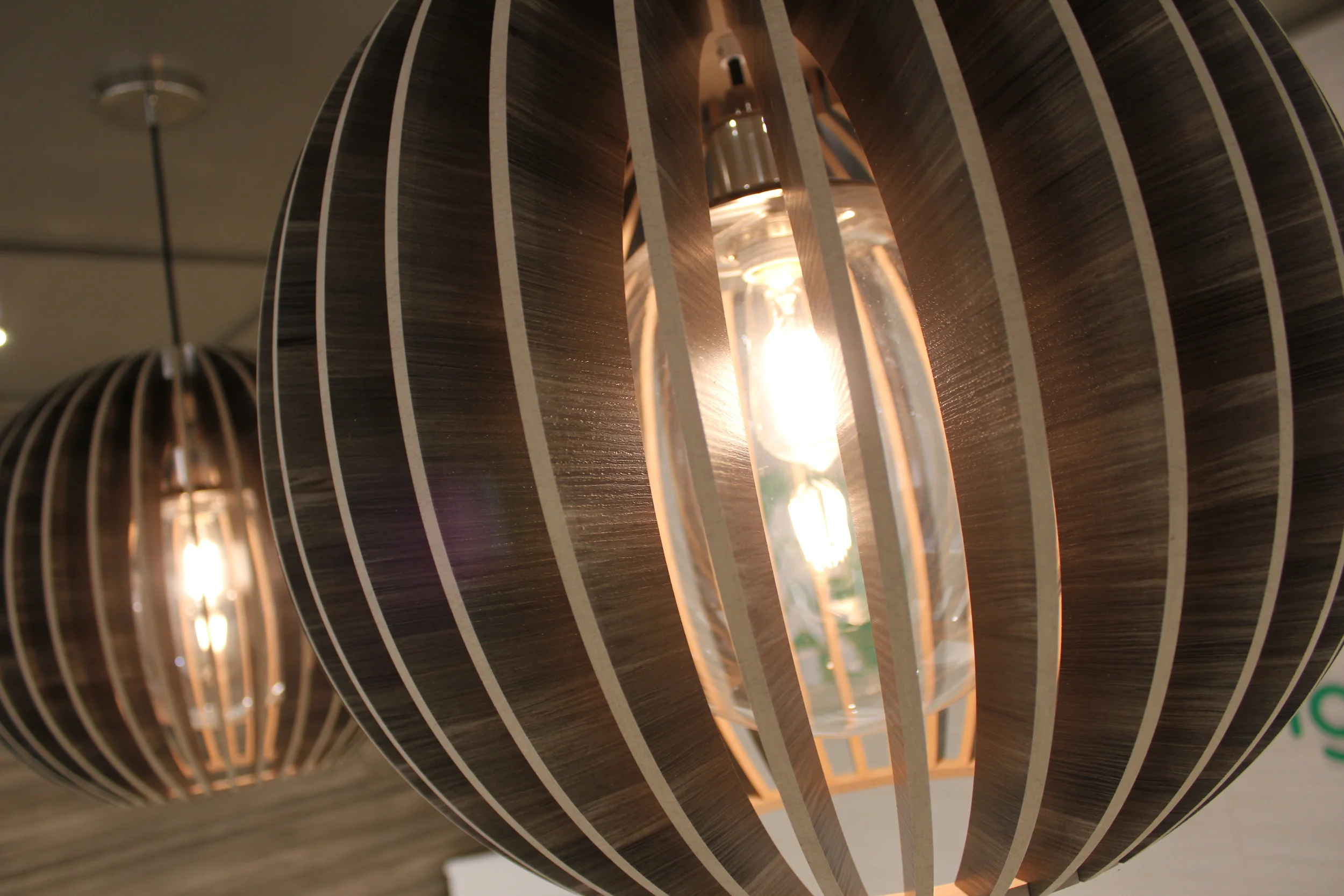 The Arauco booth is a fully custom exhibit with cutom cabinetry and millwork incorporating the client's own wood products on the strucutre and in the lights