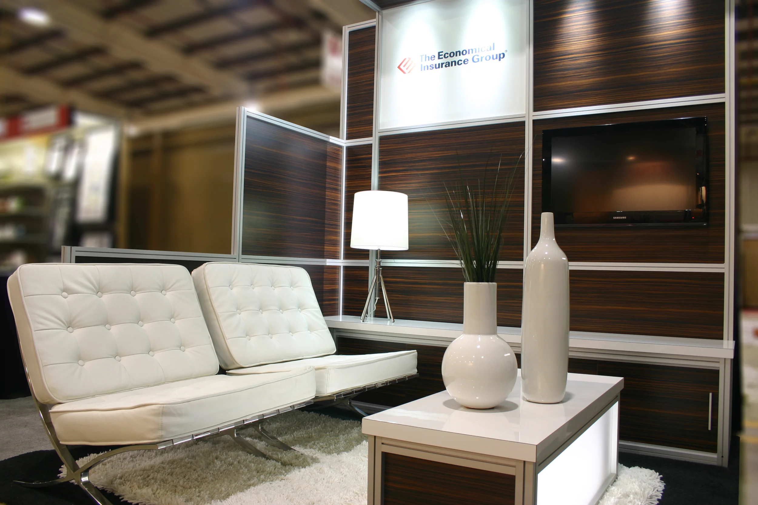 A photograph of a 10'x10' exhibit display rental including furniture and accesories